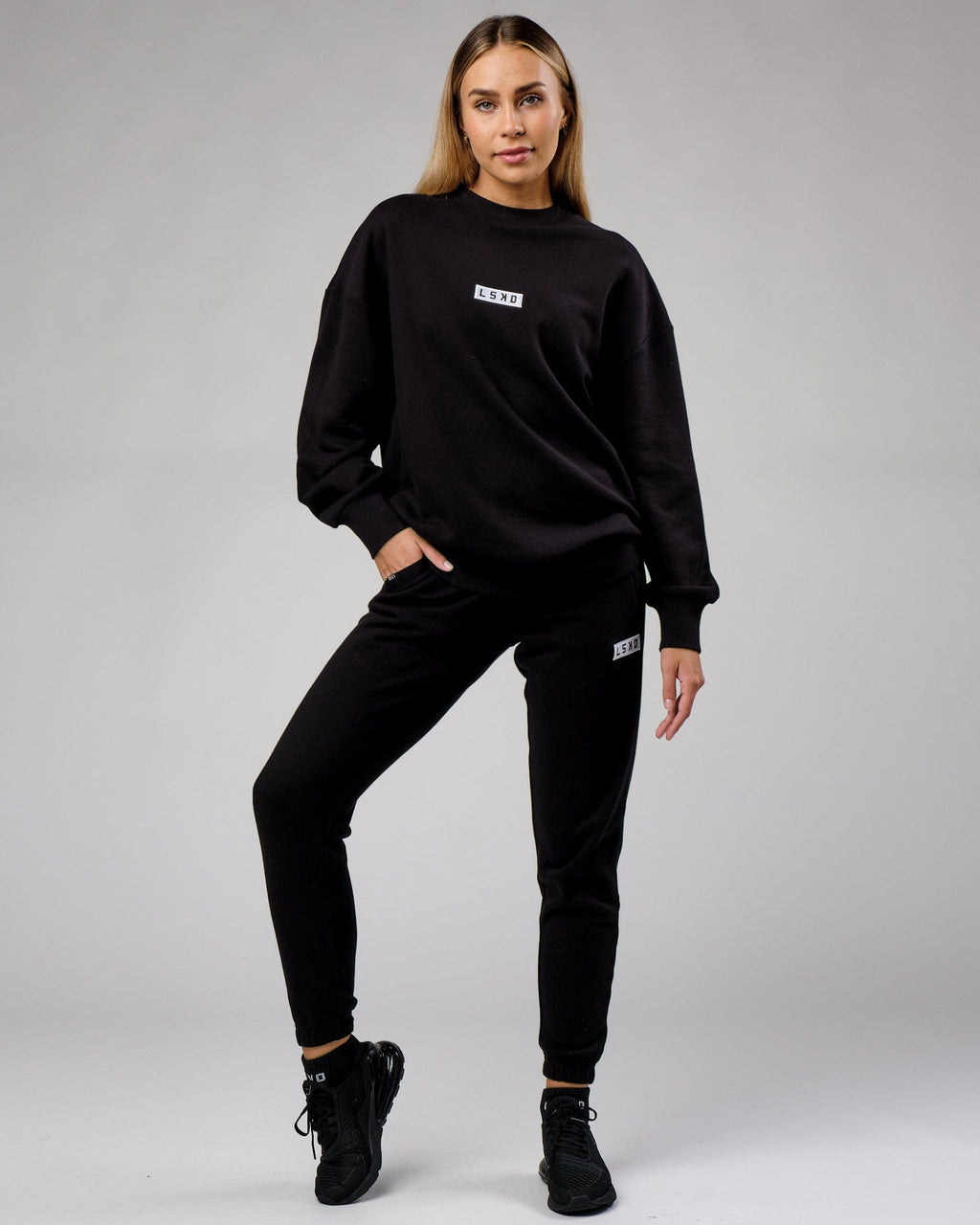 Model wearing Unisex Cornerstone Track Pant Oversize - Black