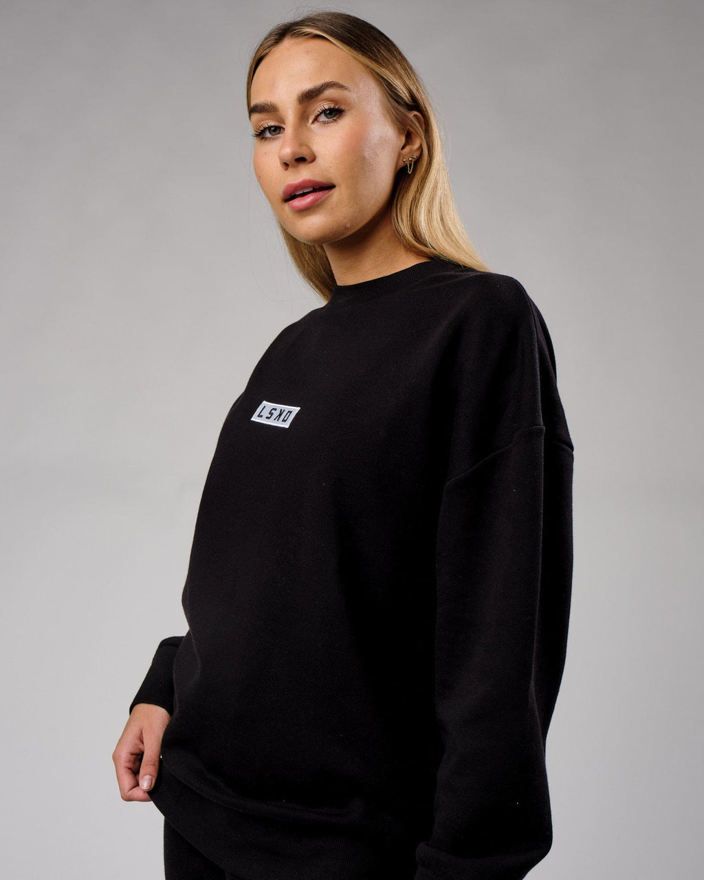 Model wearing Unisex Cornerstone Sweater Oversize - Black