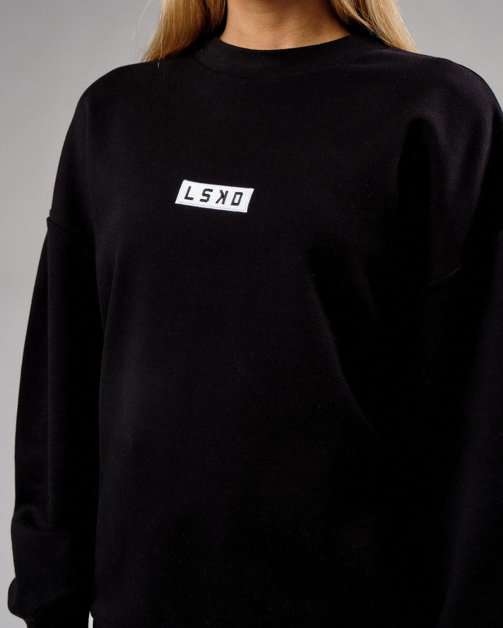 Model wearing Unisex Cornerstone Sweater Oversize - Black