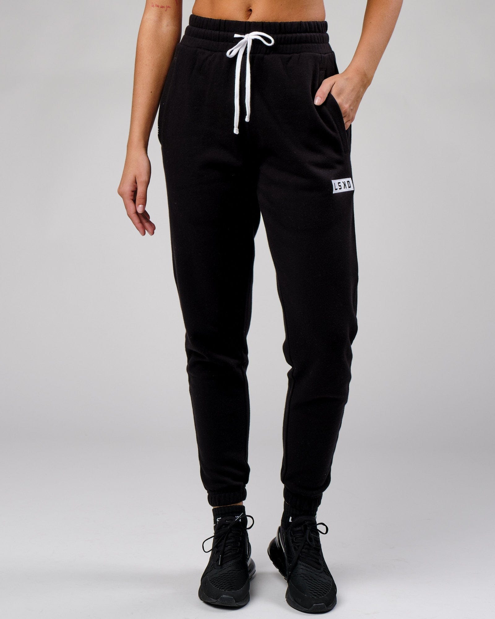 Model wearing Unisex Cornerstone Track Pant Oversize - Black
