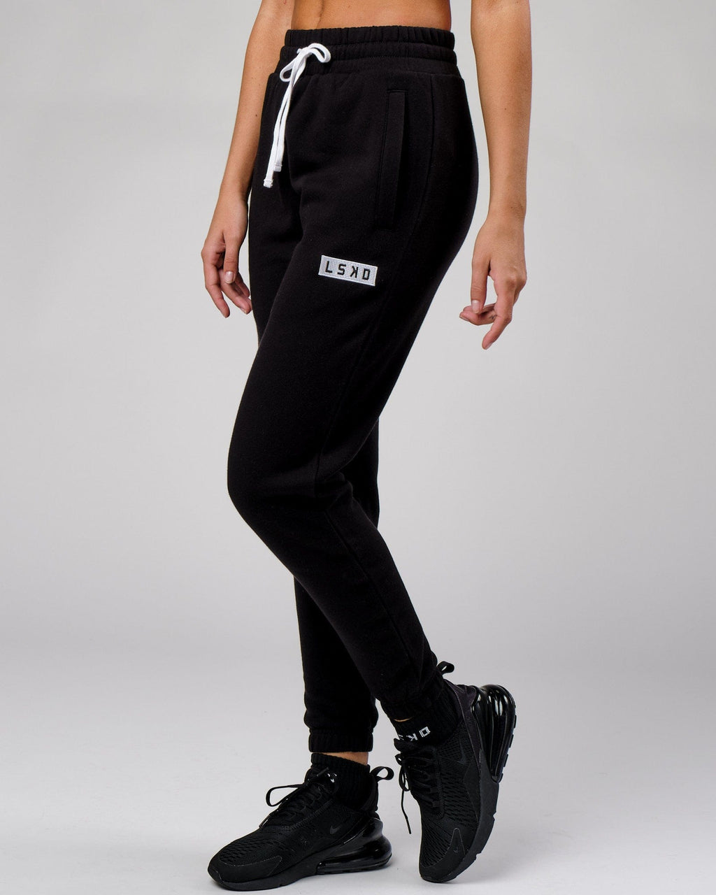 Model wearing Unisex Cornerstone Track Pant Oversize - Black
