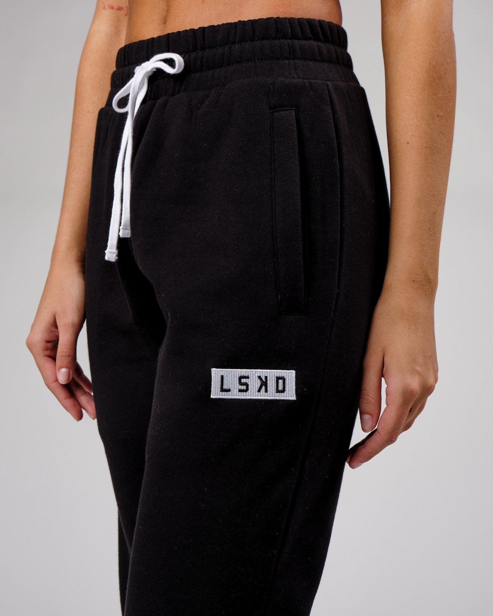 Model wearing Unisex Cornerstone Track Pant Oversize - Black