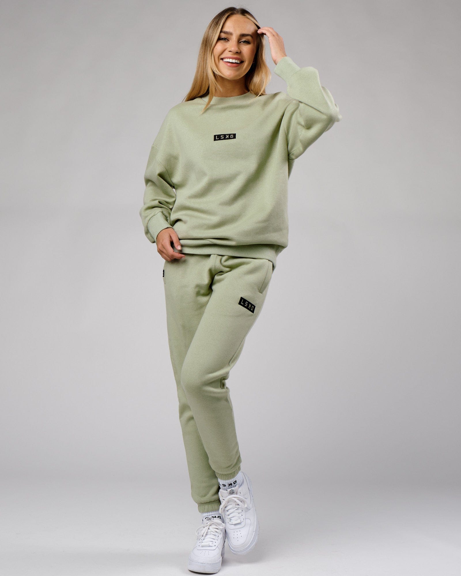 Model wearing Unisex Cornerstone Track Pant Oversize - Desert Sage