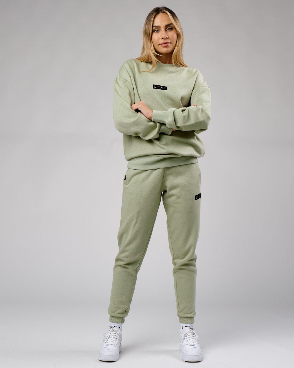 Model wearing Unisex Cornerstone Track Pant Oversize - Desert Sage
