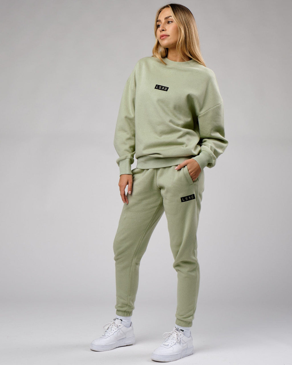 Model wearing Unisex Cornerstone Track Pant Oversize - Desert Sage
