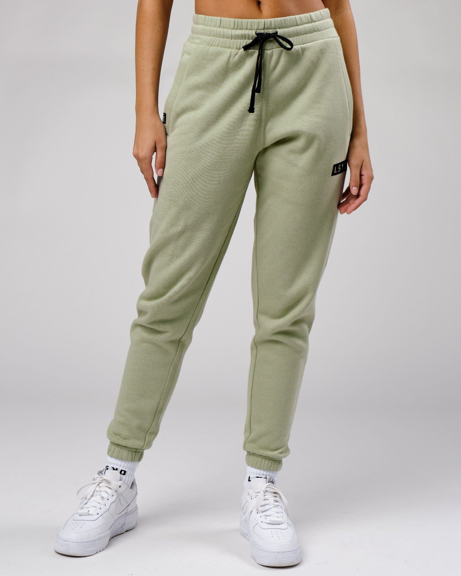 Model wearing Unisex Cornerstone Track Pant Oversize - Desert Sage