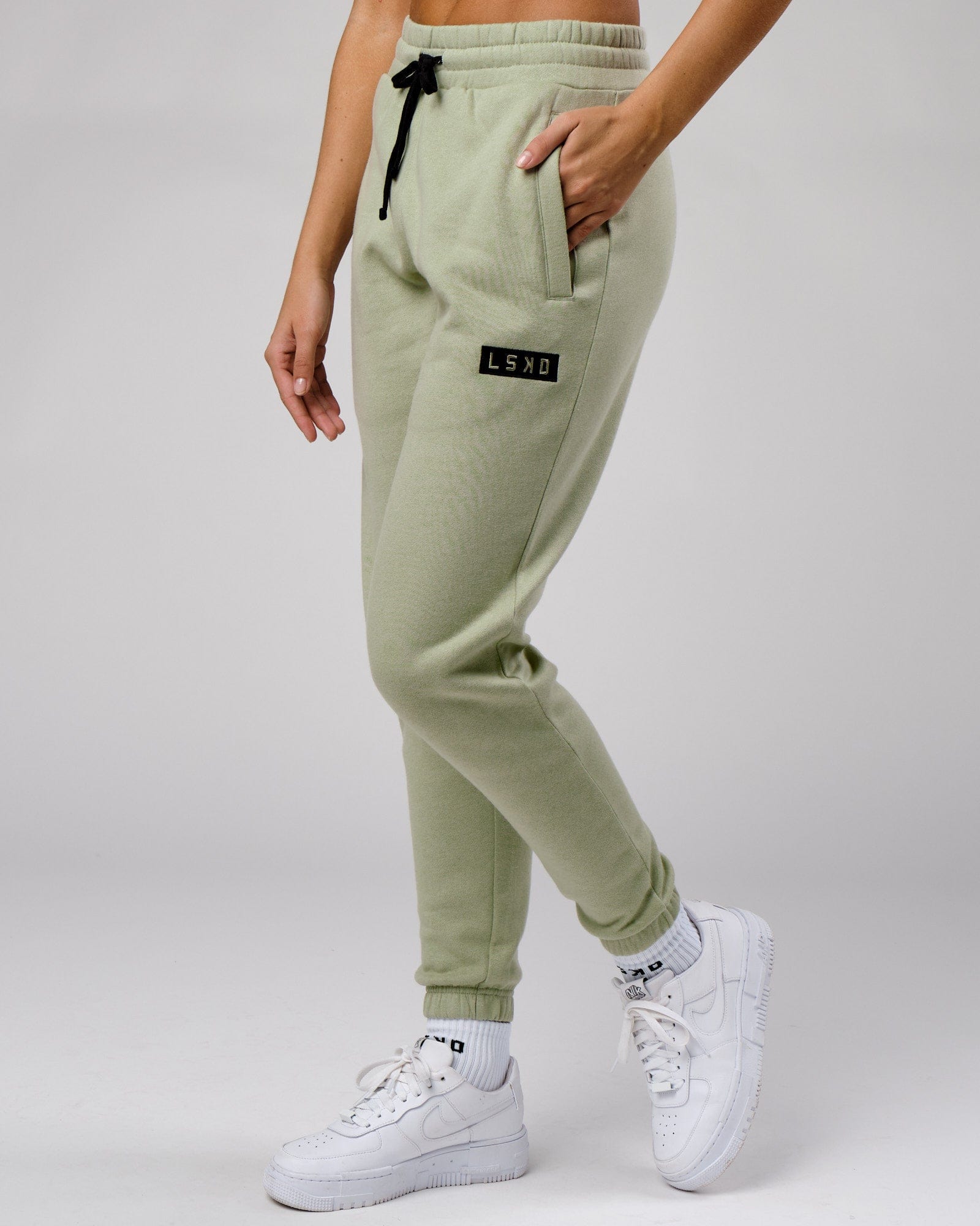 Model wearing Unisex Cornerstone Track Pant Oversize - Desert Sage