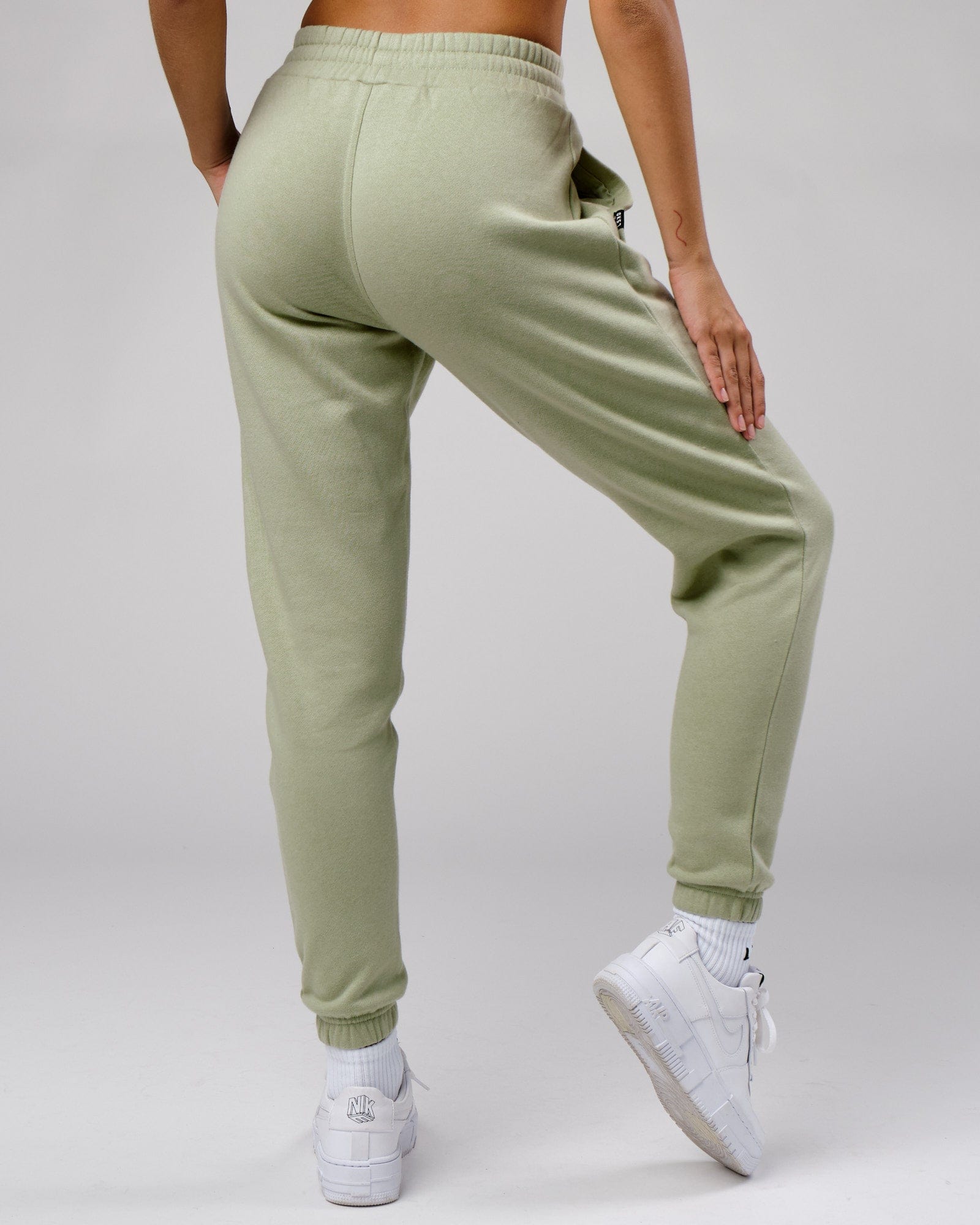 Model wearing Unisex Cornerstone Track Pant Oversize - Desert Sage