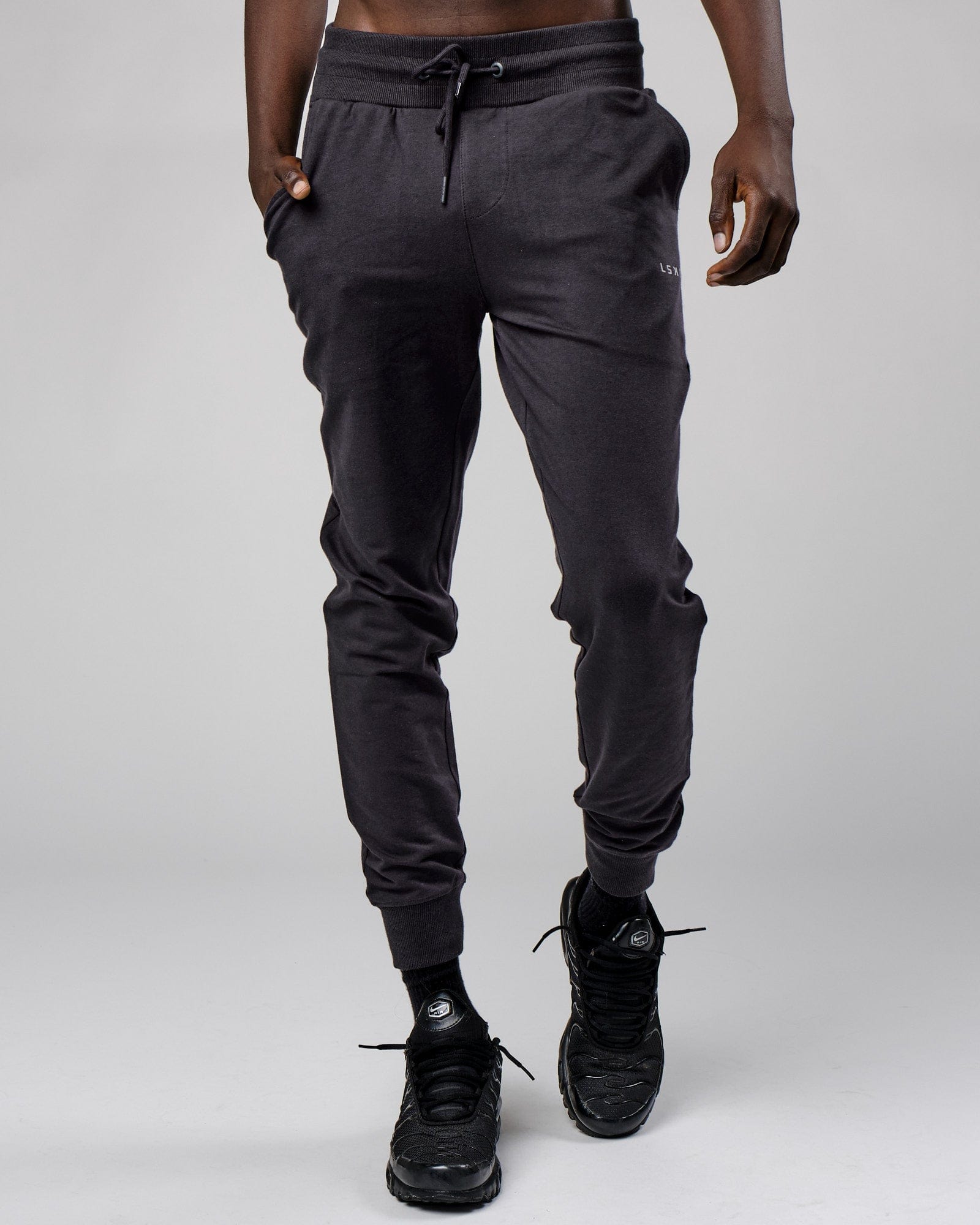 Model wearing Base Track Pant - Phantom