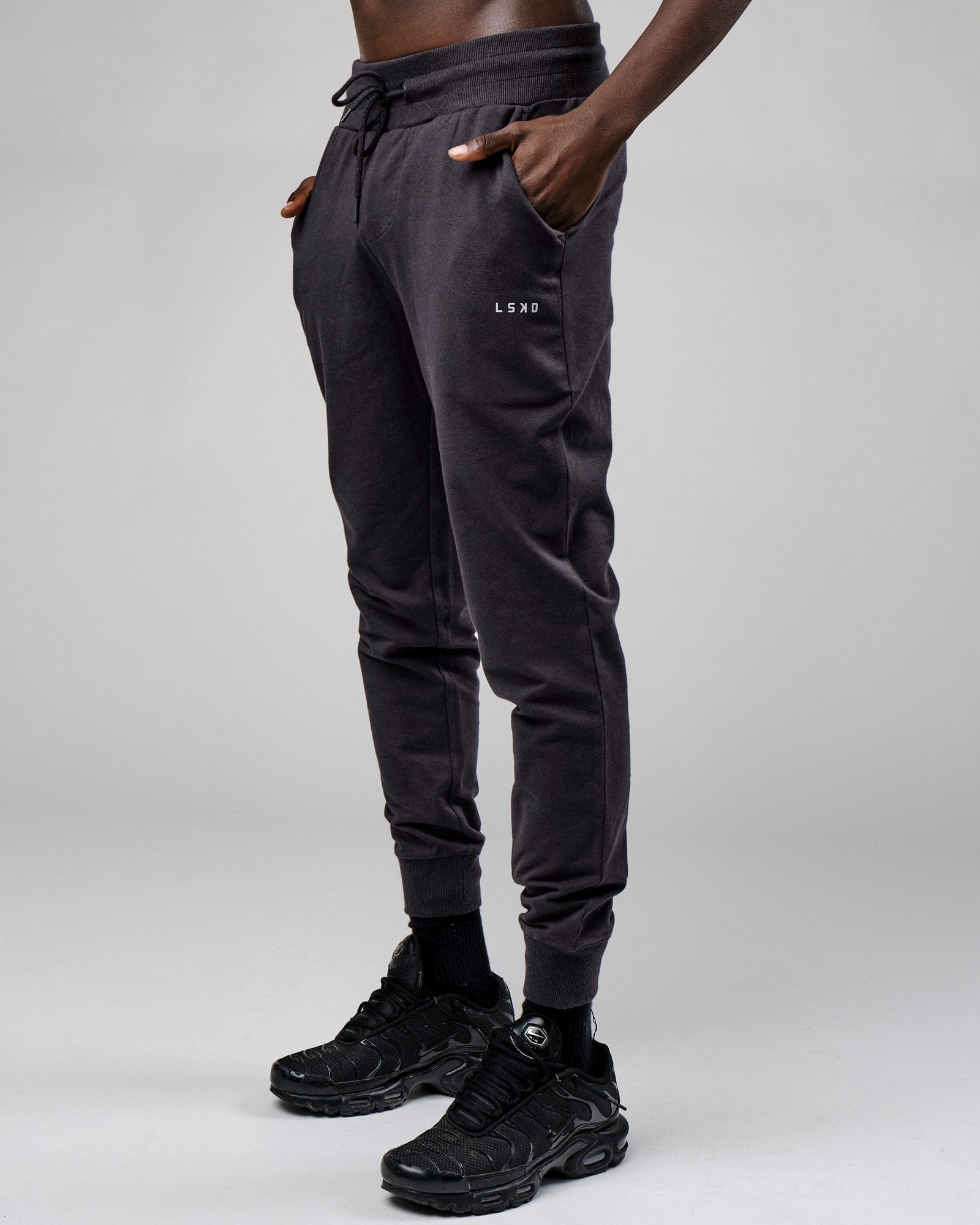 Model wearing Base Track Pant - Phantom