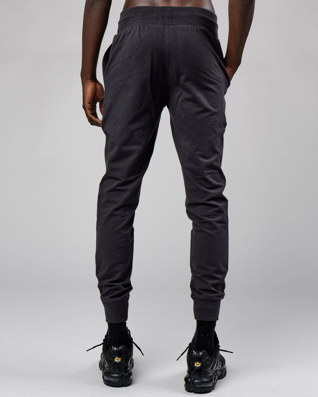 Model wearing Base Track Pant - Phantom