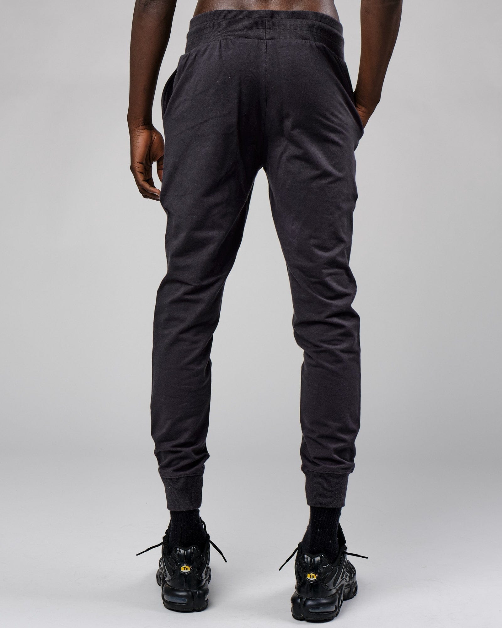Model wearing Base Track Pant - Phantom