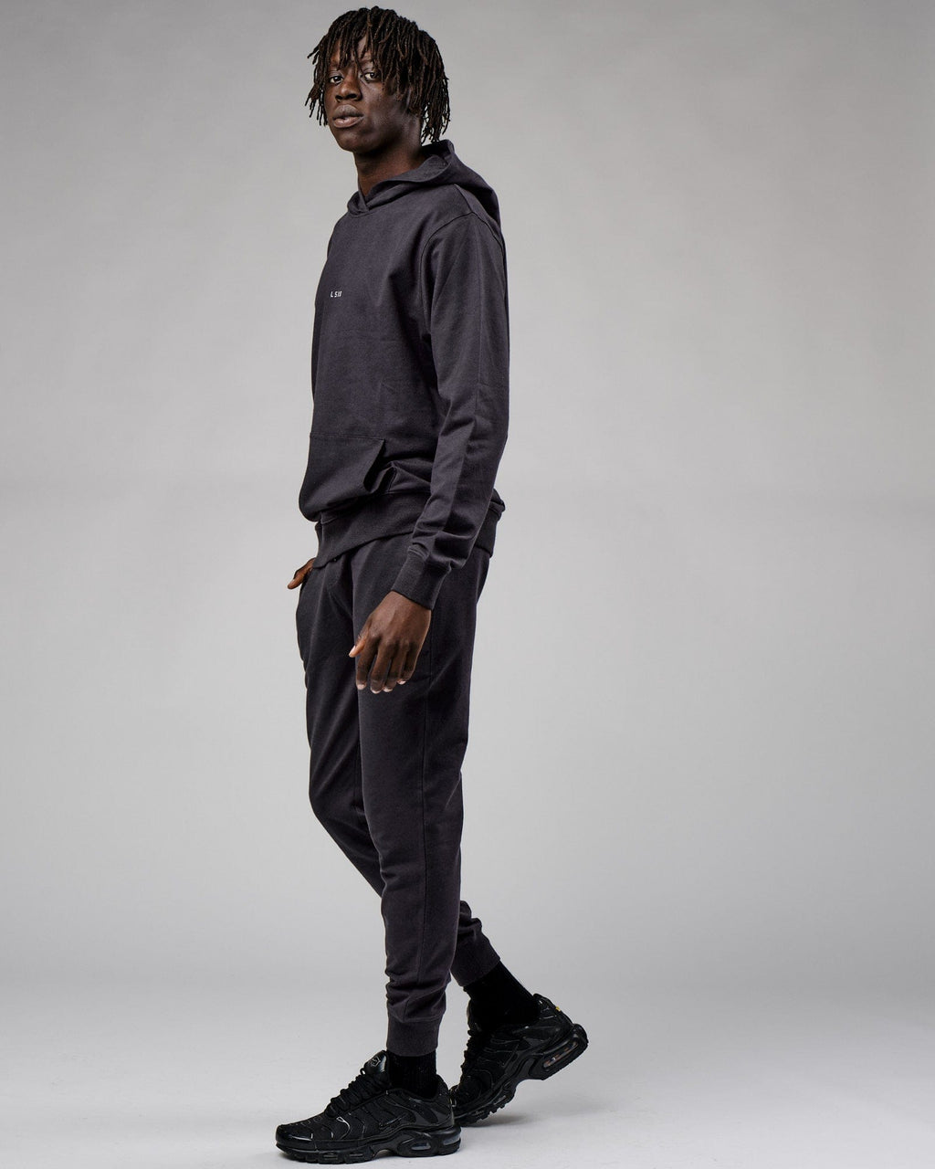 Model wearing Base Track Pant - Phantom