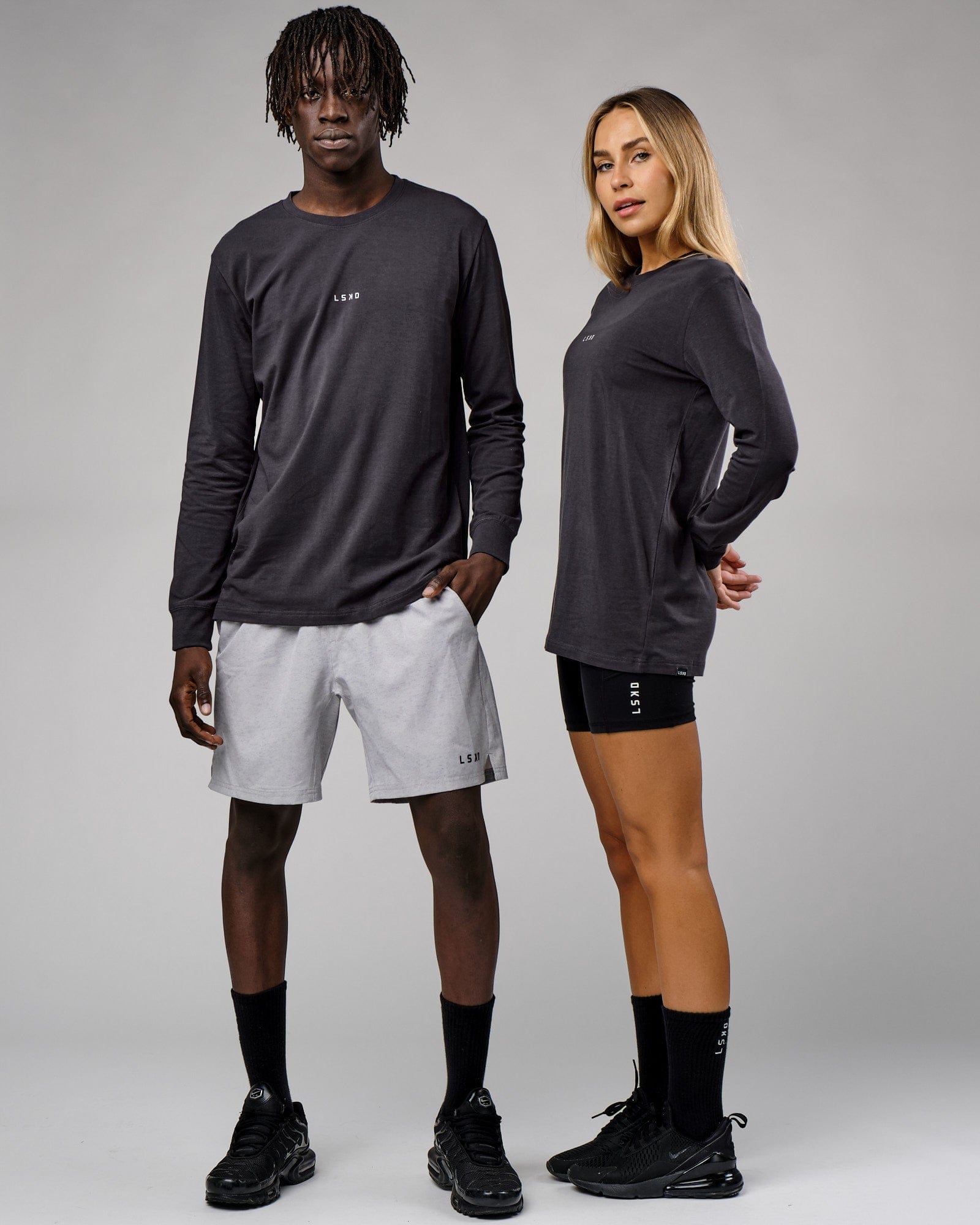 Model wearing Unisex Base LS Tee - Phantom