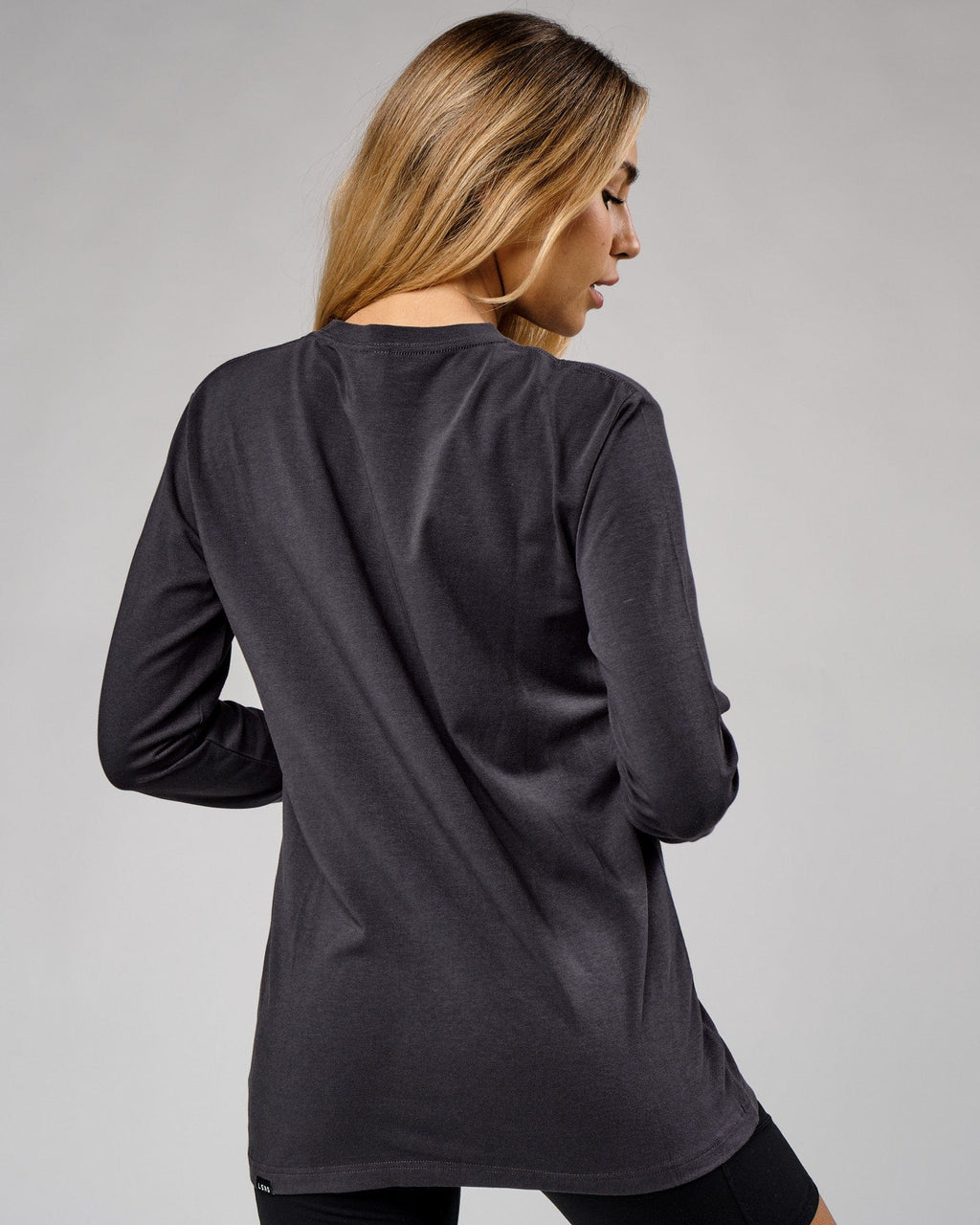 Model wearing Unisex Base LS Tee - Phantom