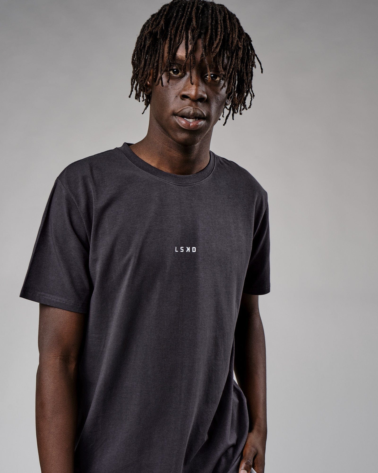 Model wearing Base Tee - Phantom