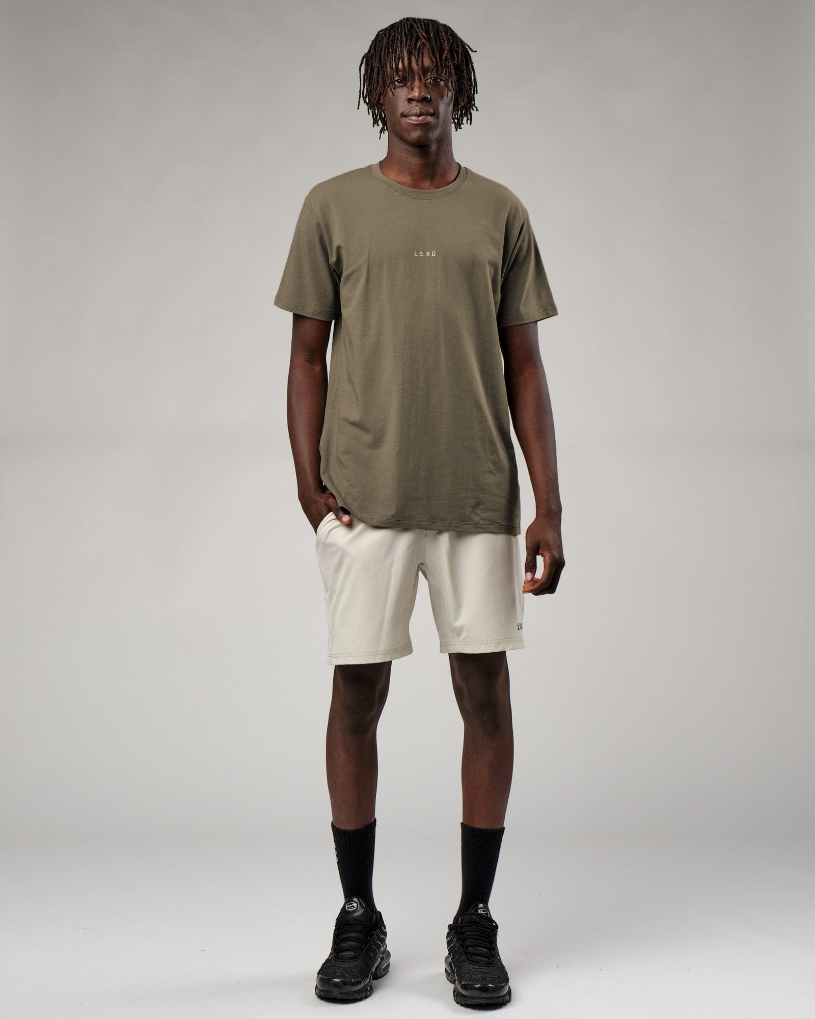 Model wearing Base Tee - Walnut Grey