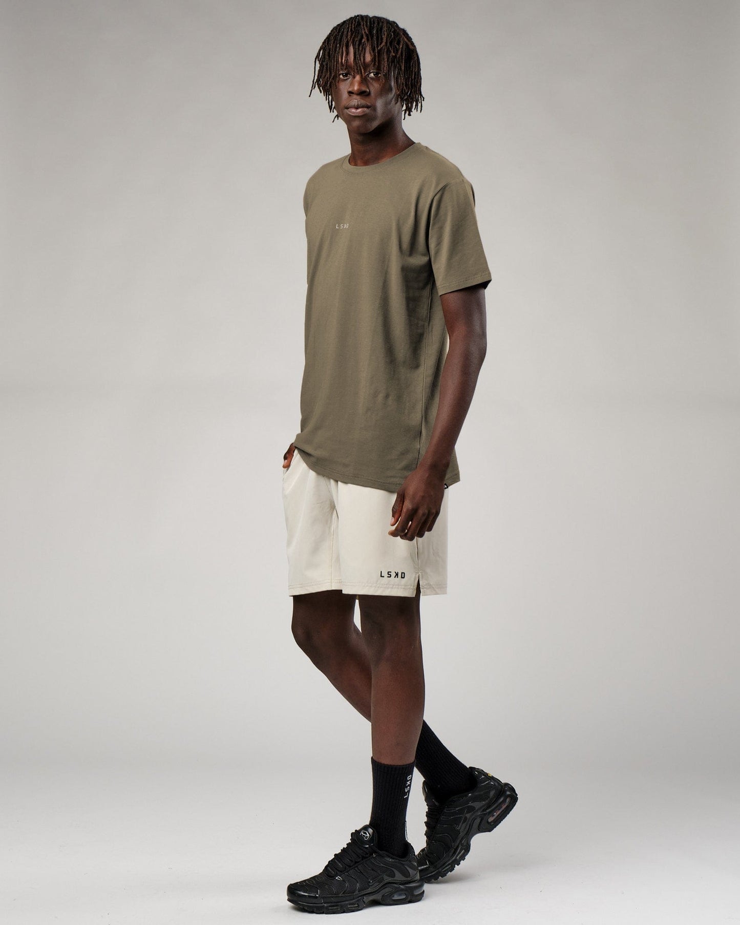 Model wearing Base Tee - Walnut Grey