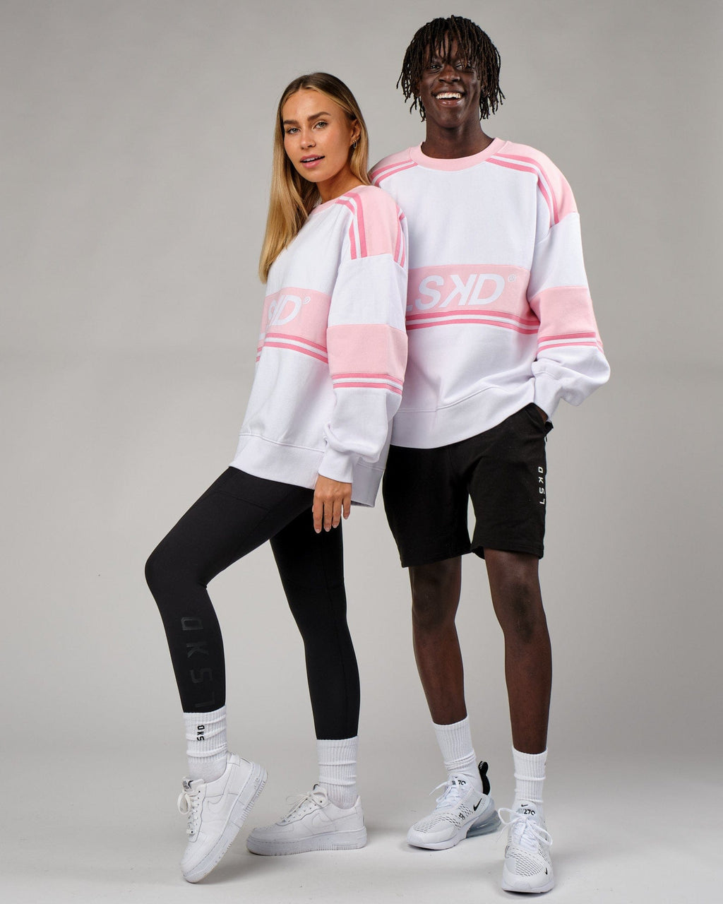 Model wearing Unisex A-Team Sweater Oversize - Petal Pink-White