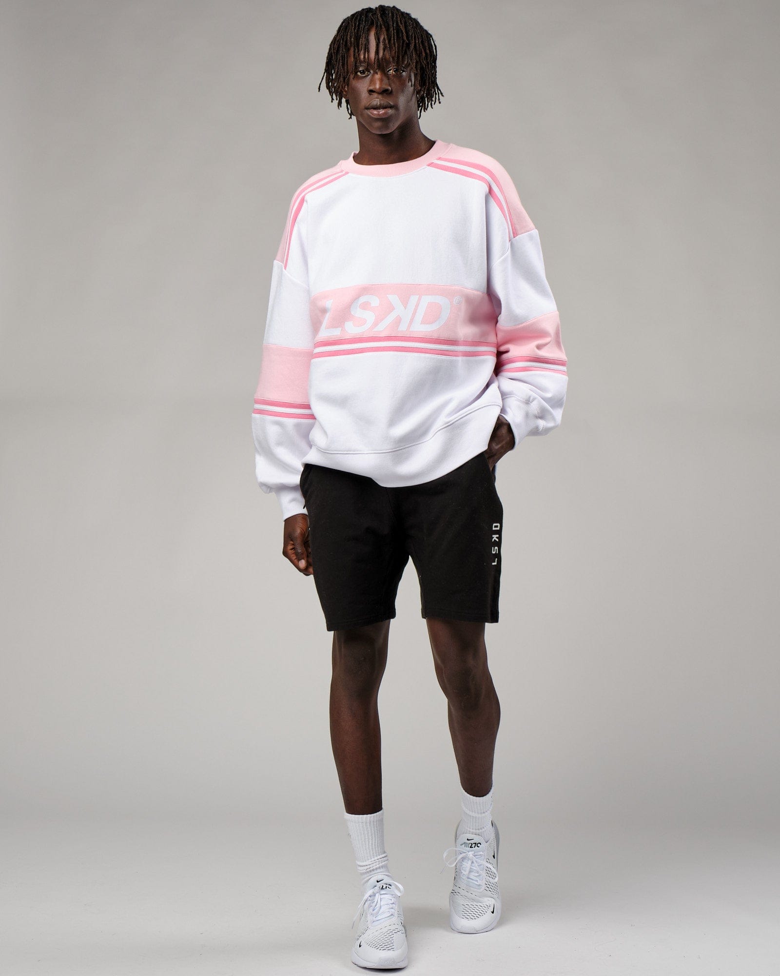 Model wearing Unisex A-Team Sweater Oversize - Petal Pink-White