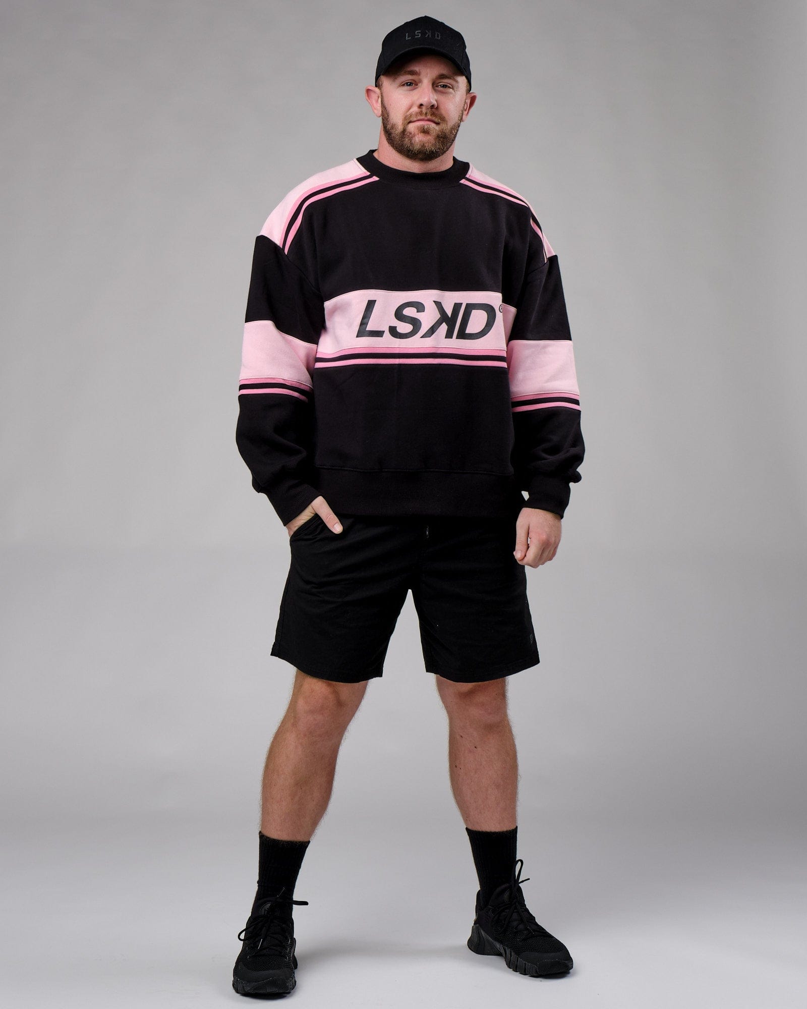 Model wearing Unisex A-Team Sweater Oversize - Black-Petal Pink