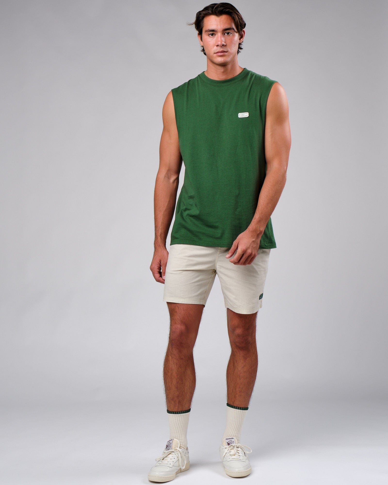 Model wearing Badge Tank Oversize - Eden Green