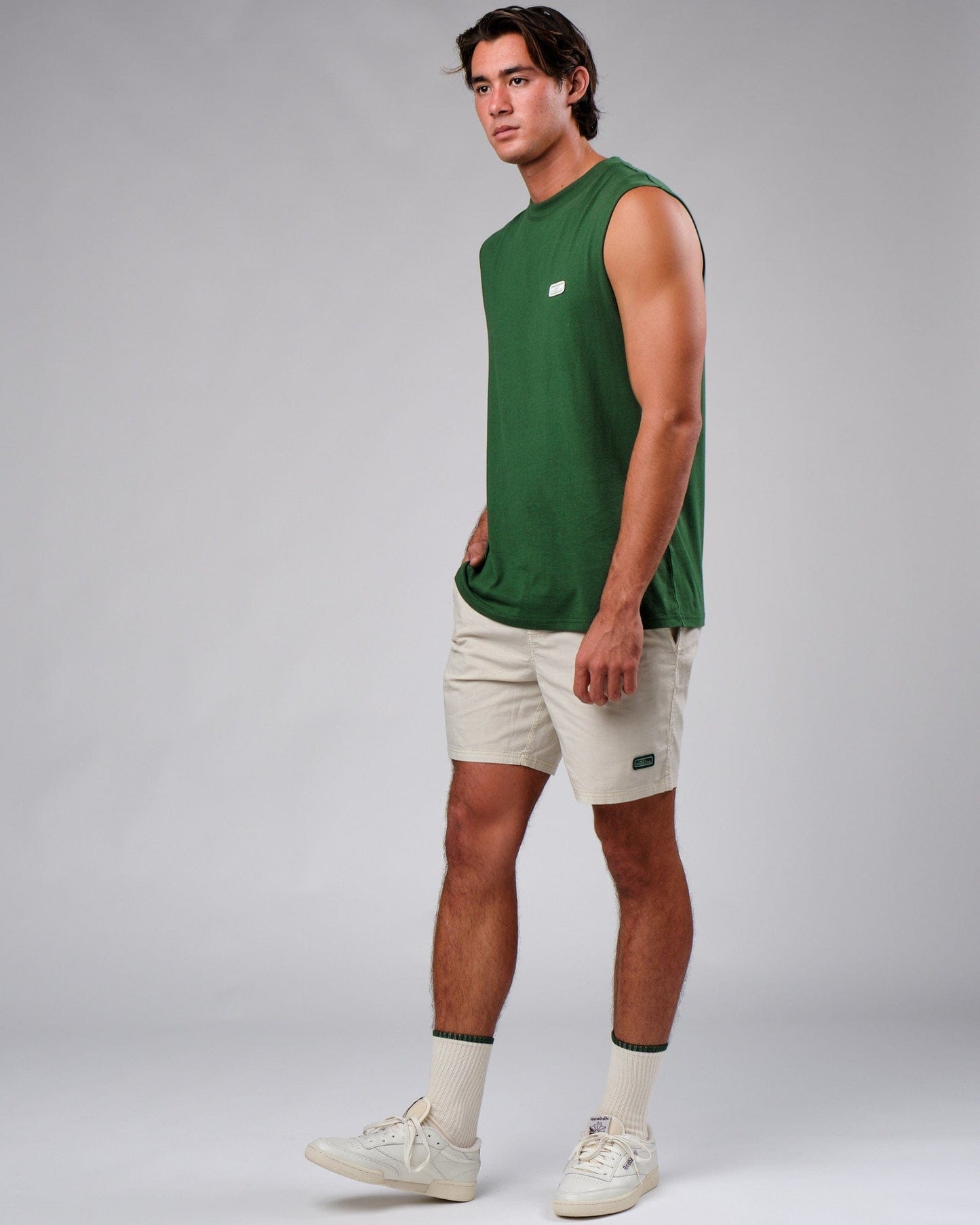 Model wearing Badge Tank Oversize - Eden Green