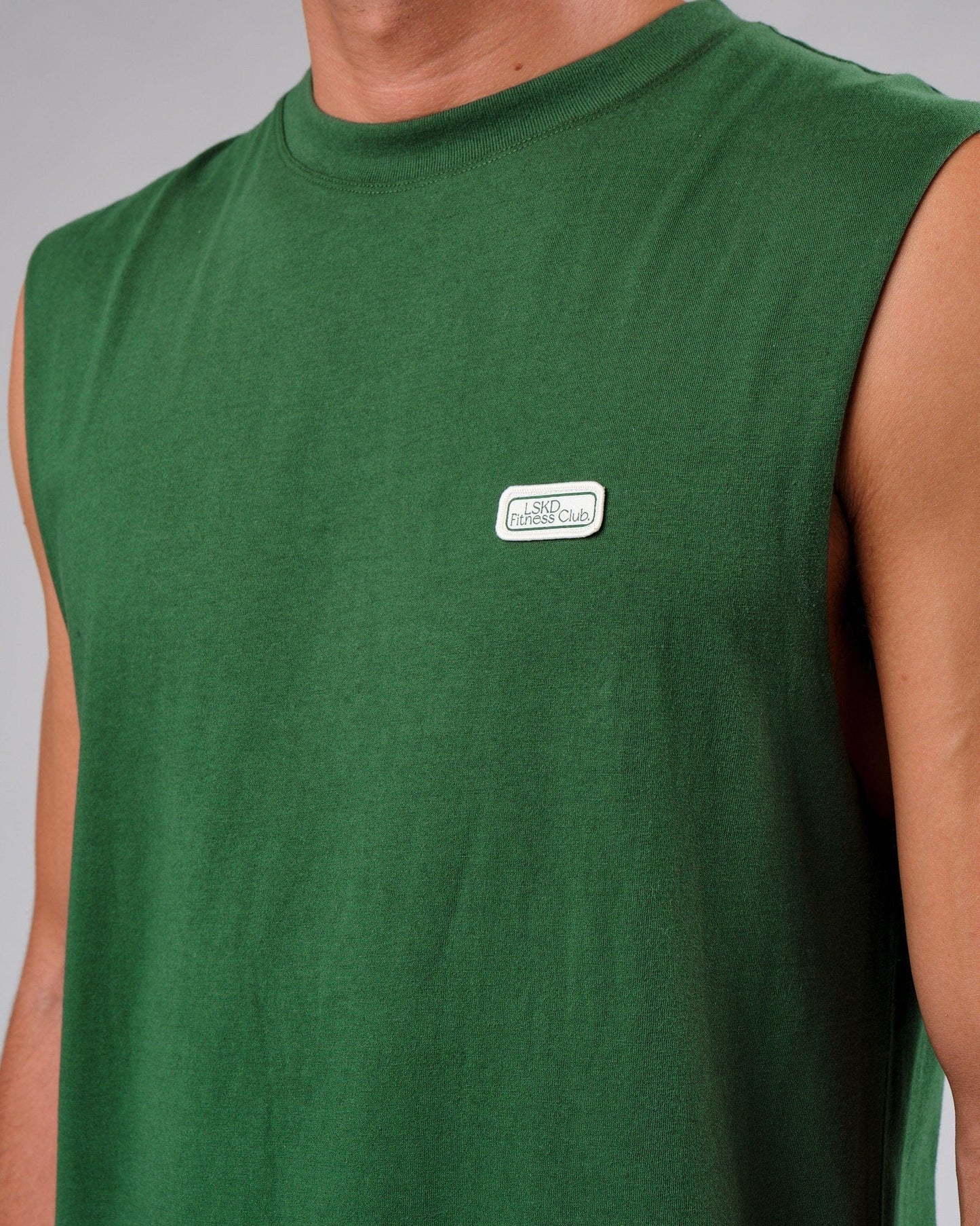 Model wearing Badge Tank Oversize - Eden Green