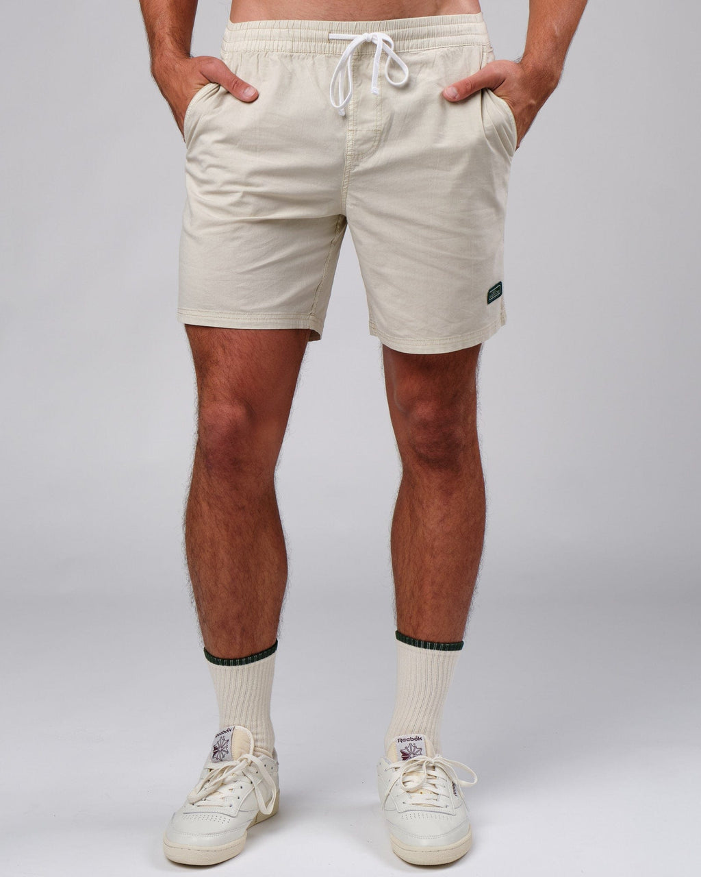 Model wearing Badge Short - Washed Cream