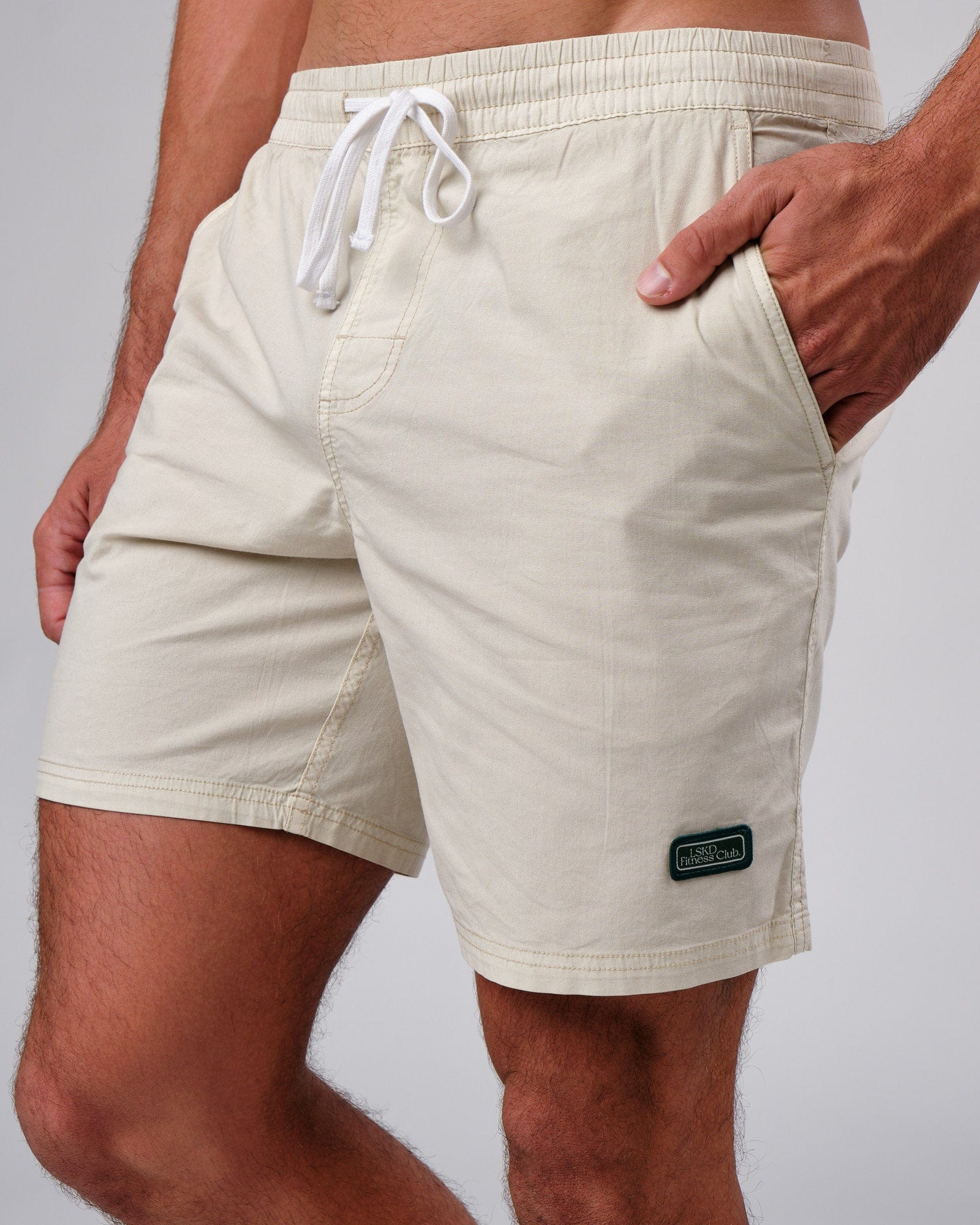 Model wearing Badge Short - Washed Cream