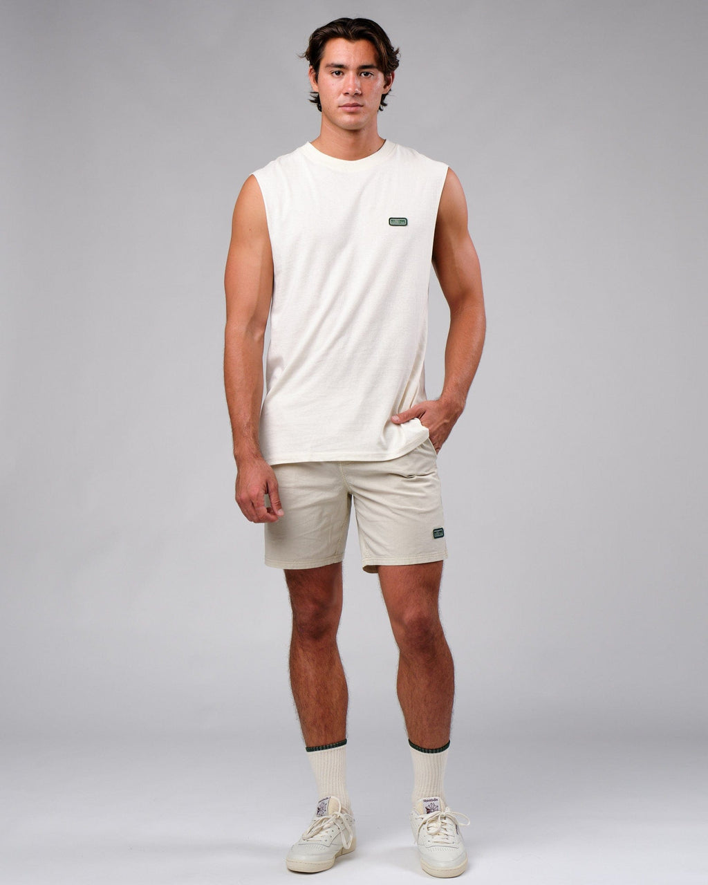 Model wearing Badge Short - Washed Cream