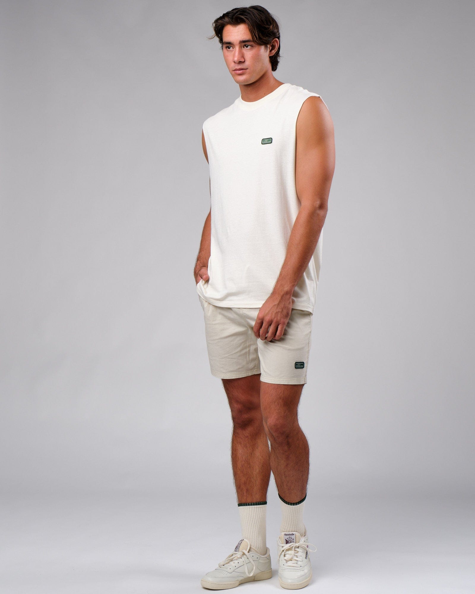 Model wearing Badge Short - Washed Cream