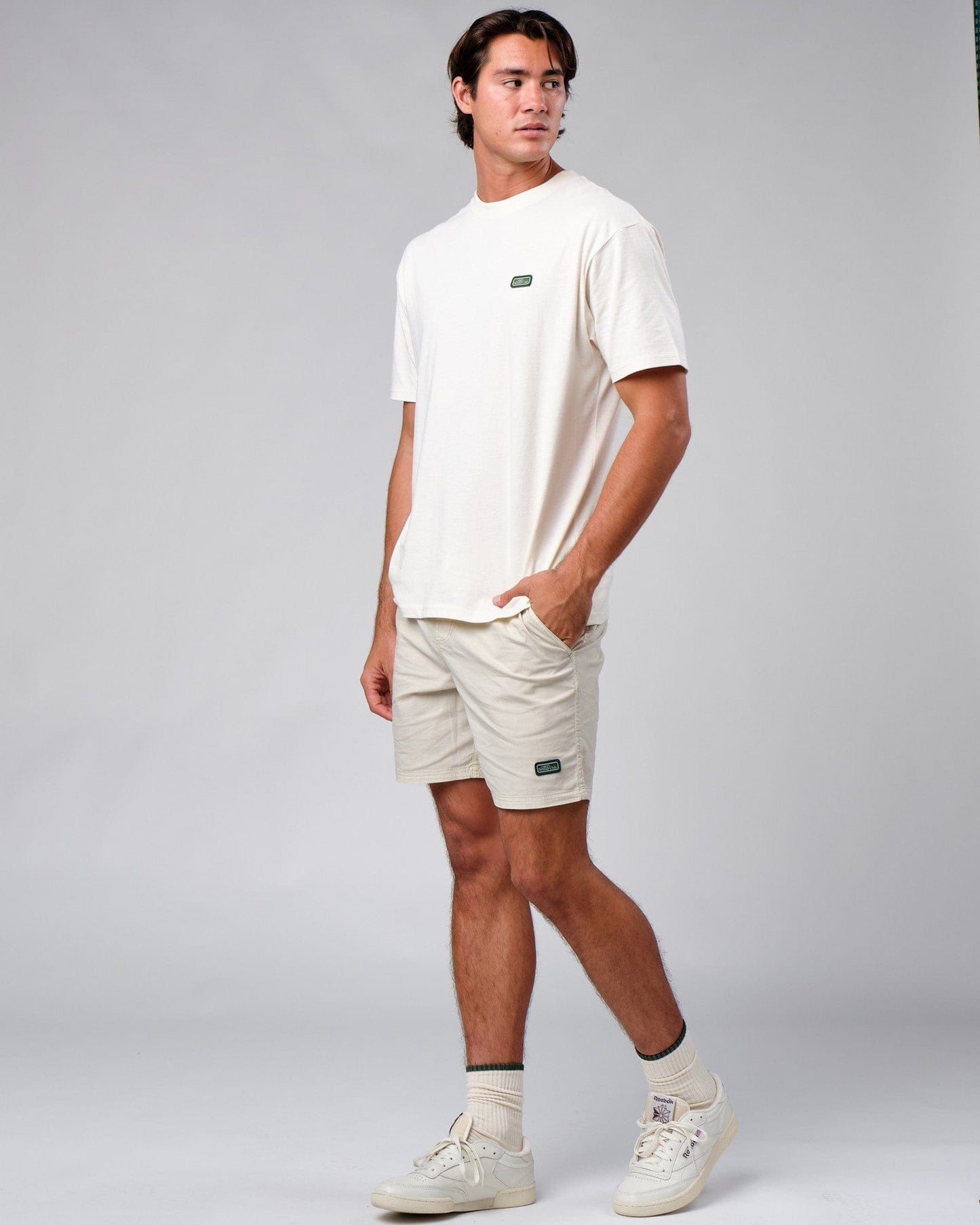 Model wearing Badge Tee Oversize - Cream