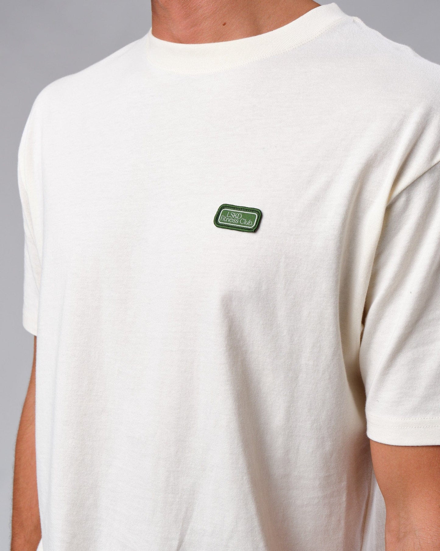 Model wearing Badge Tee Oversize - Cream