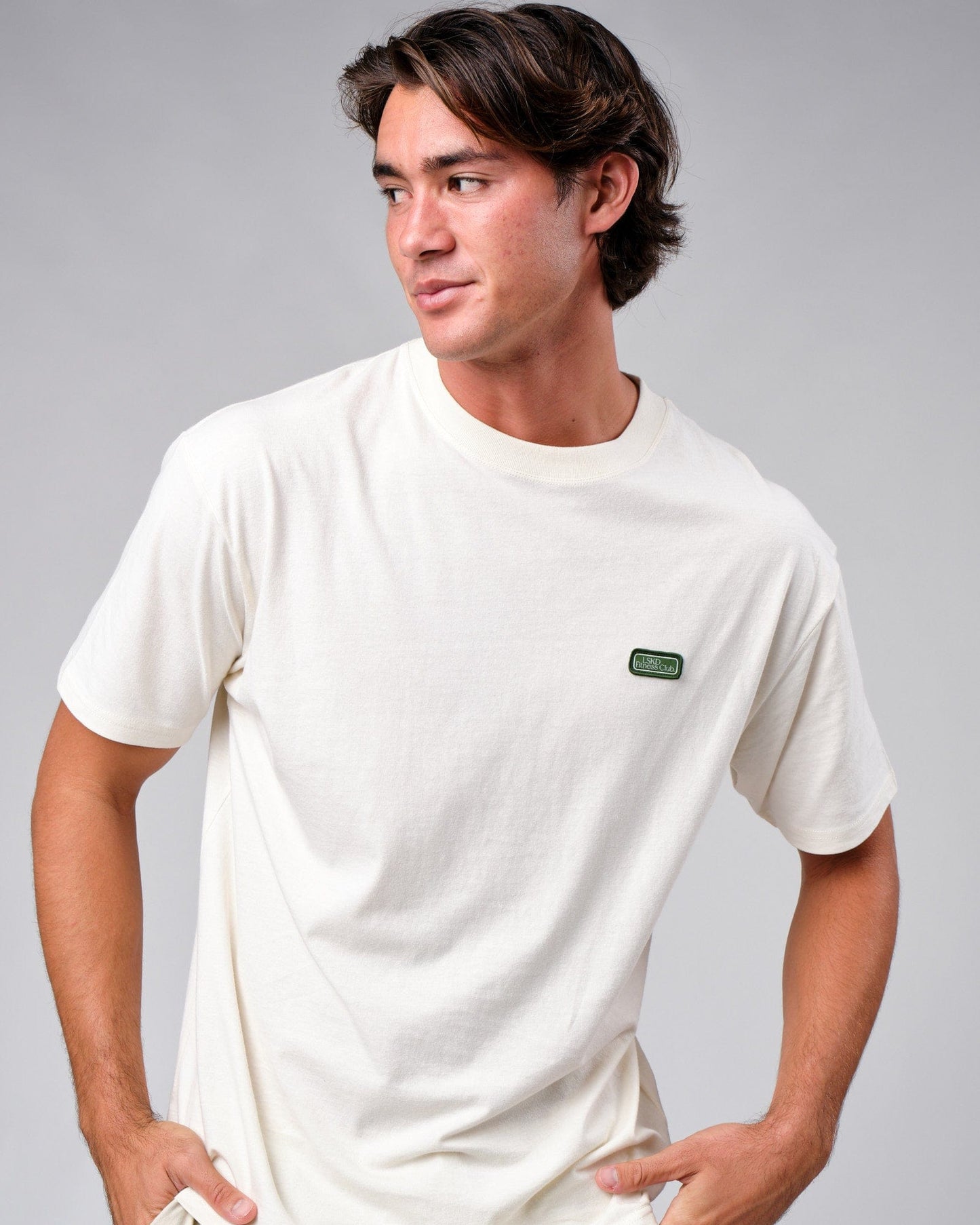 Model wearing Badge Tee Oversize - Cream