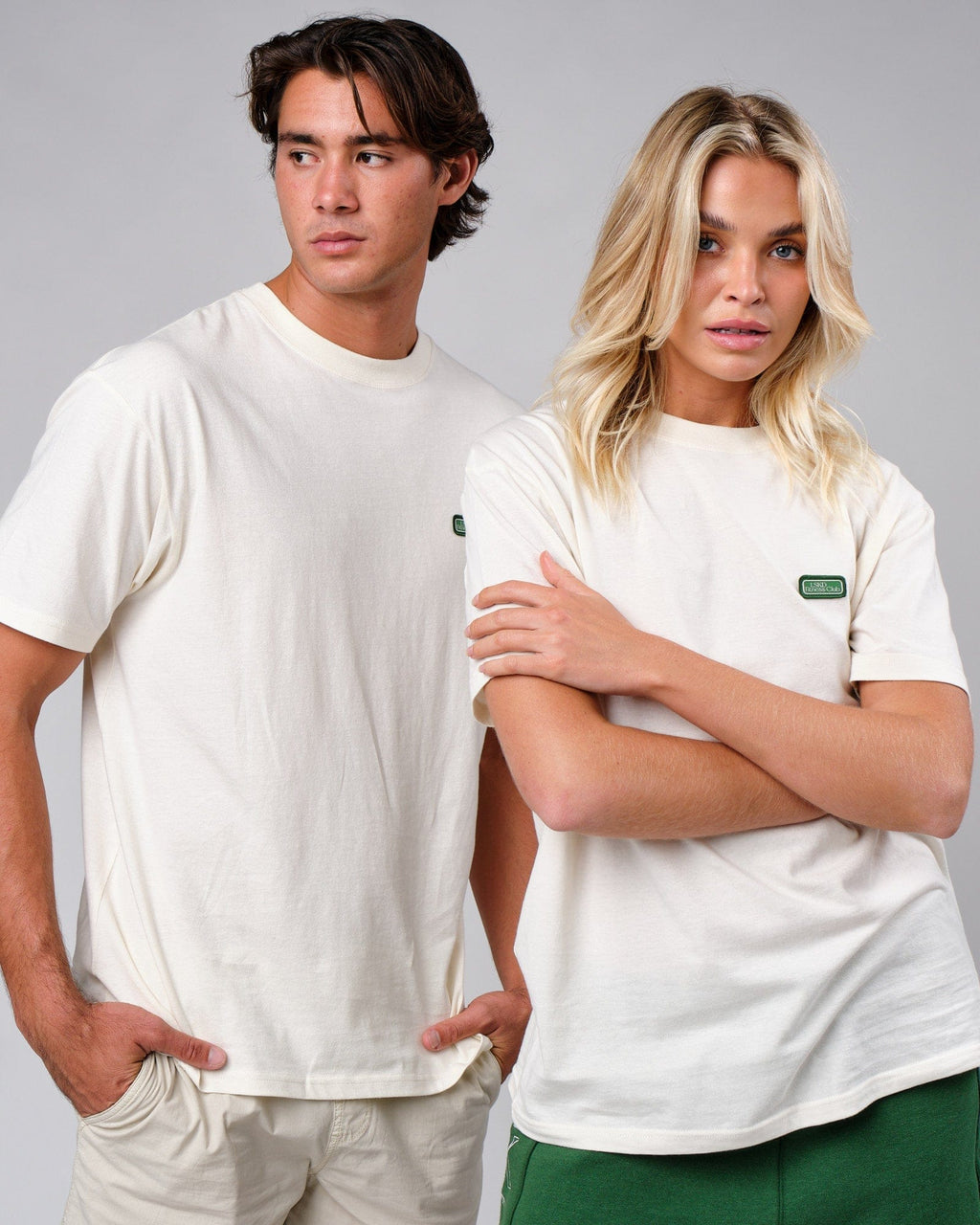 Model wearing Unisex Badge Tee Oversize - Cream