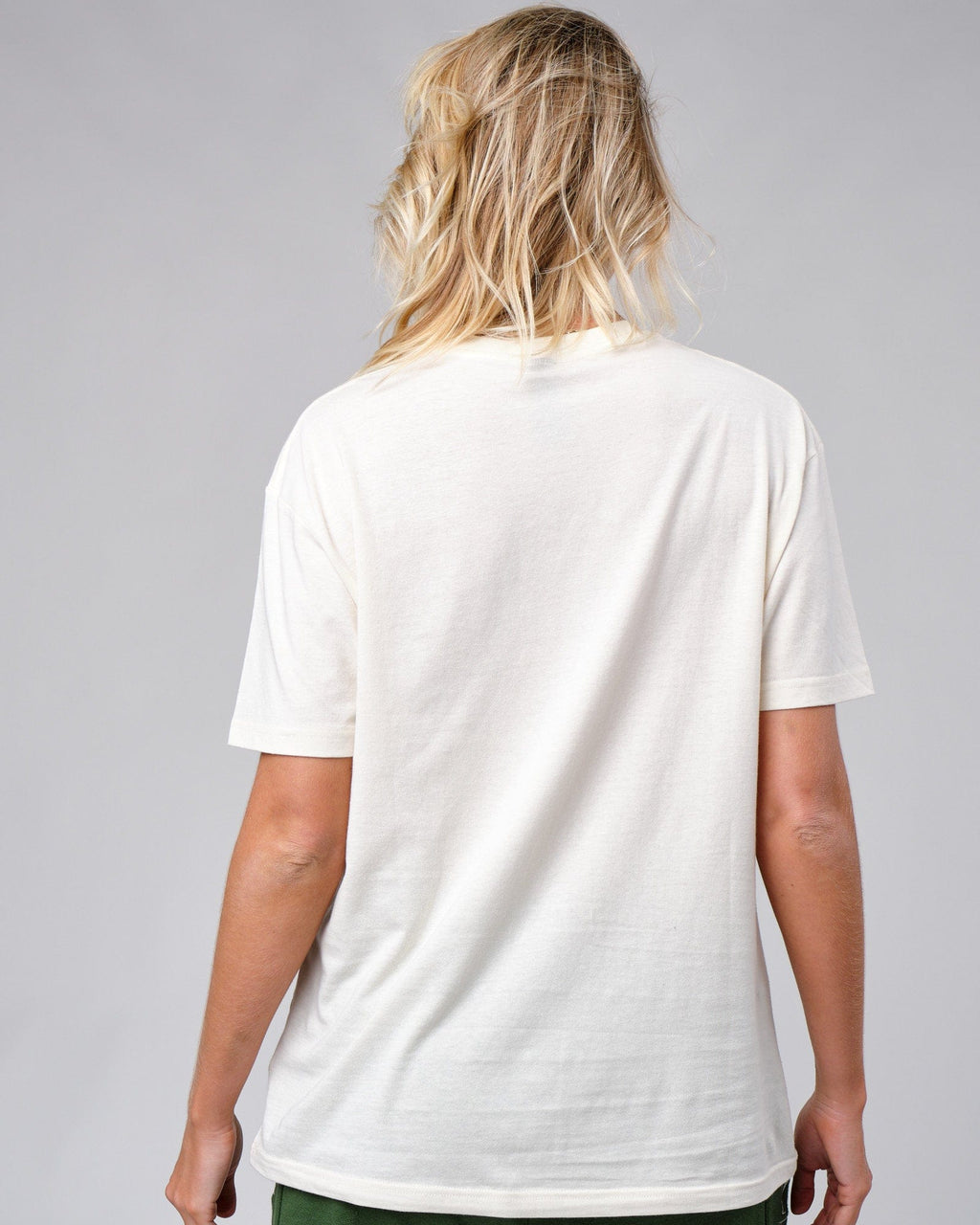 Model wearing Unisex Badge Tee Oversize - Cream