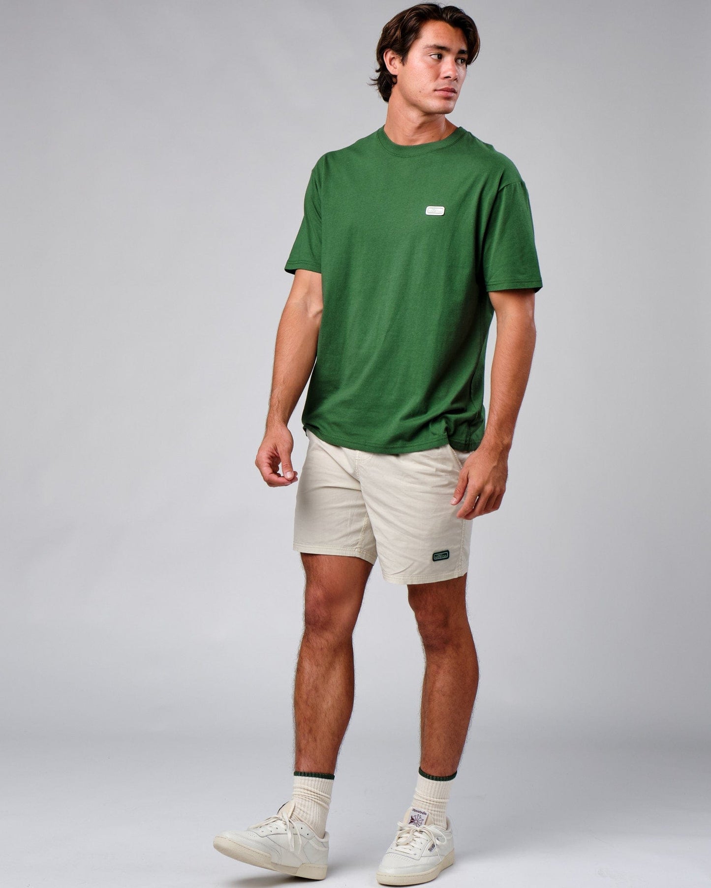 Model wearing Badge Tee Oversize - Eden Green