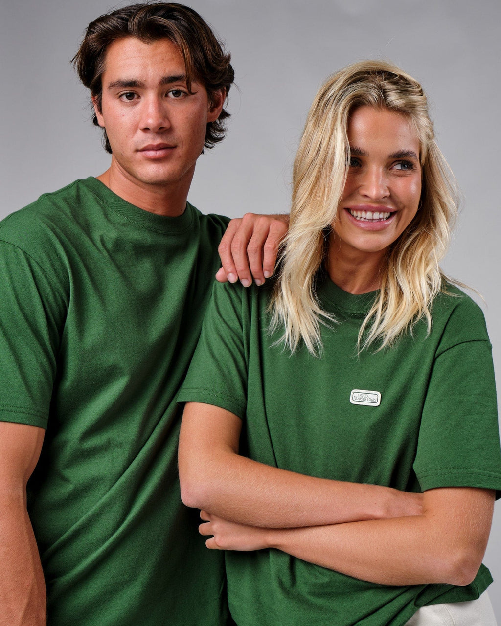 Model wearing Unisex Badge Tee Oversize - Eden Green