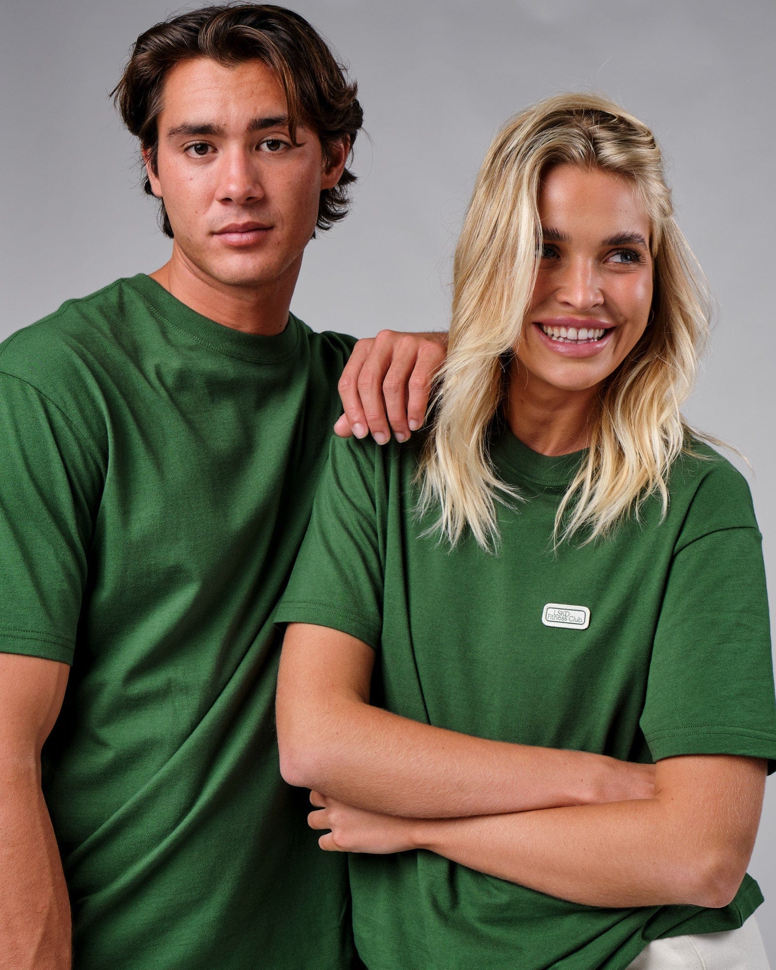 Model wearing Unisex Badge Tee Oversize - Eden Green