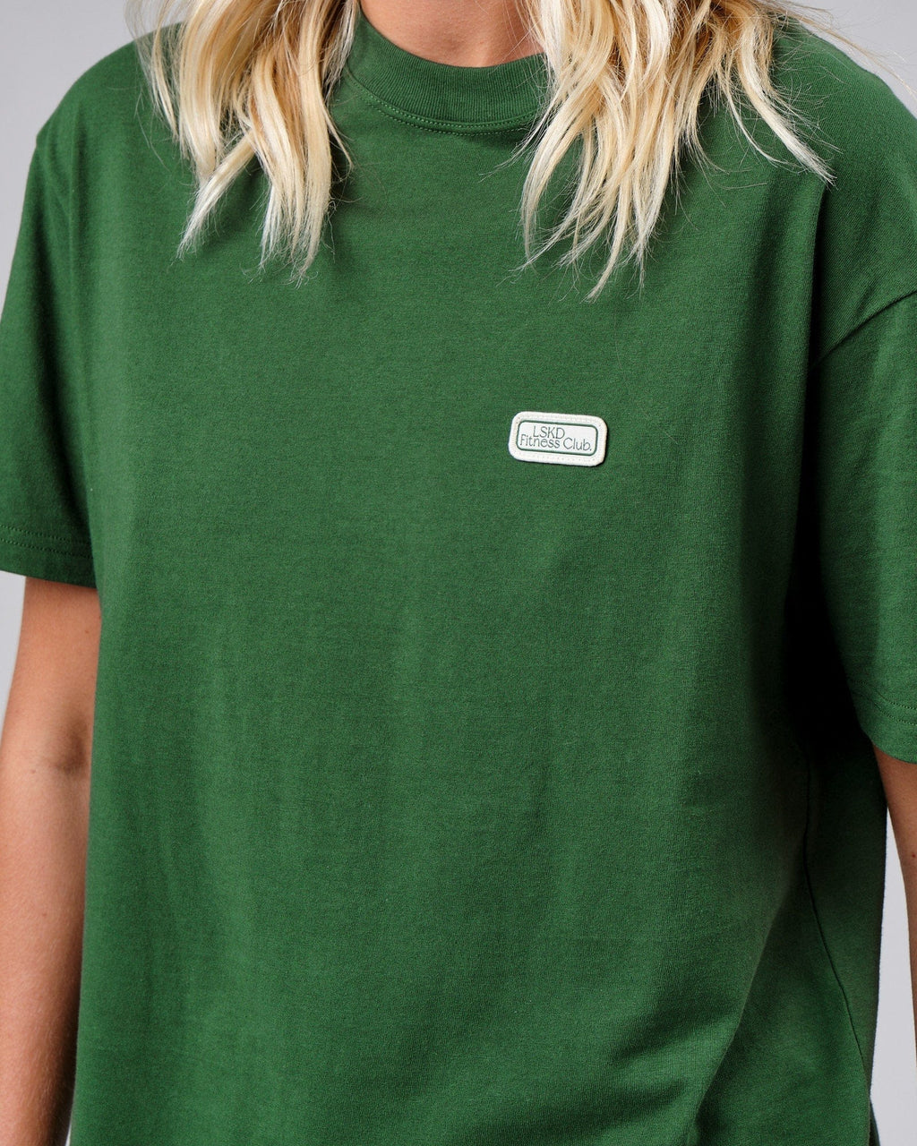 Model wearing Unisex Badge Tee Oversize - Eden Green