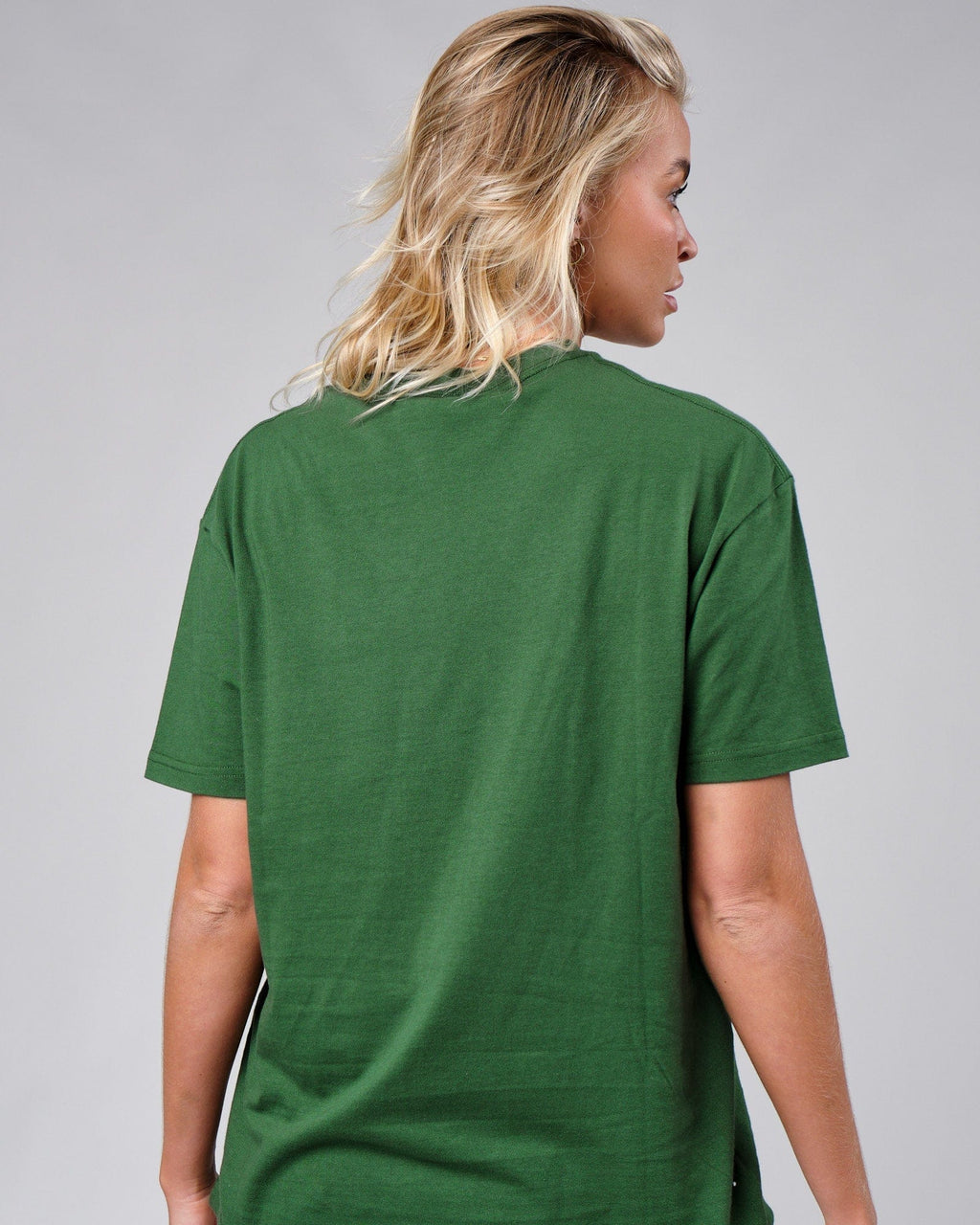 Model wearing Unisex Badge Tee Oversize - Eden Green