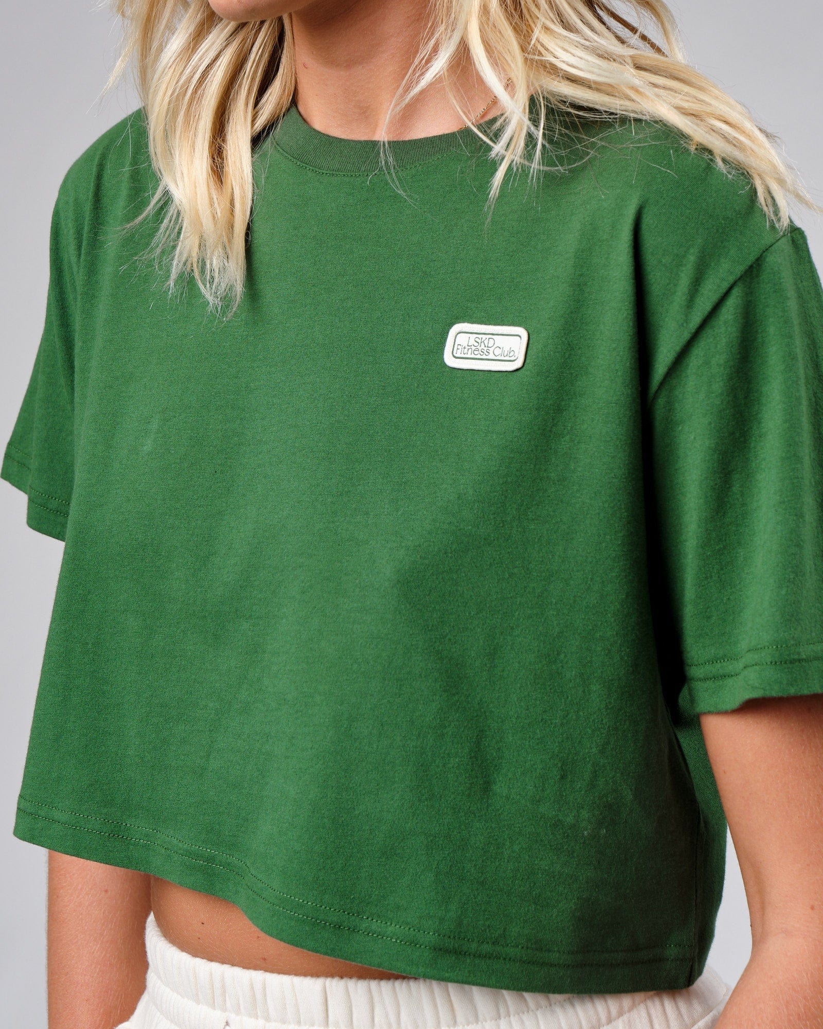 Model wearing Badge Tee - Eden Green