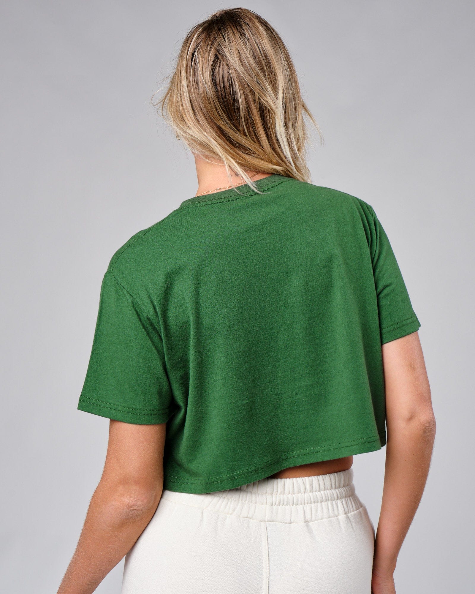 Model wearing Badge Tee - Eden Green