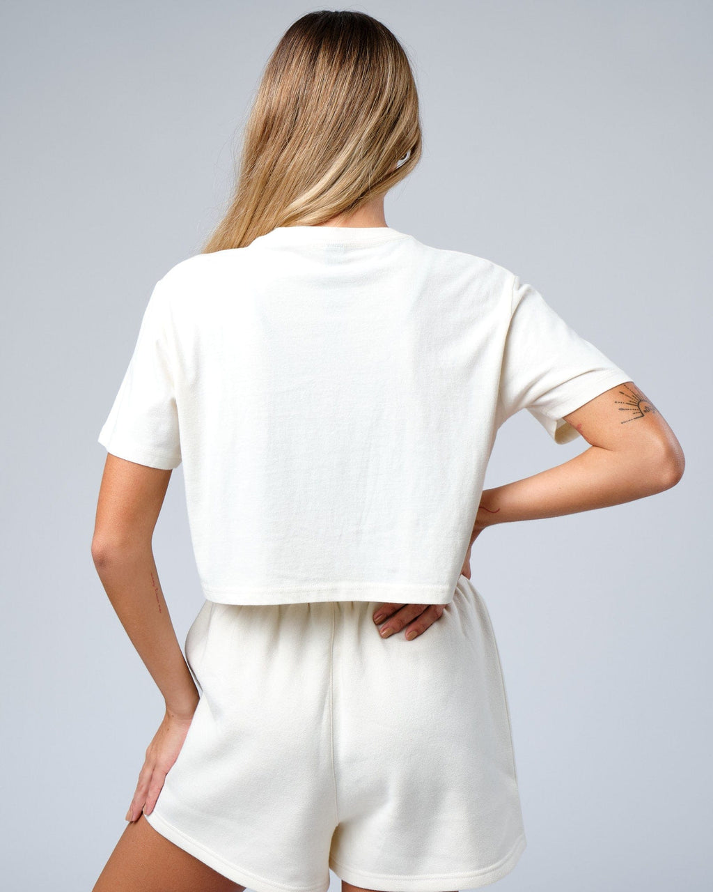 Model wearing Badge Tee - Cream