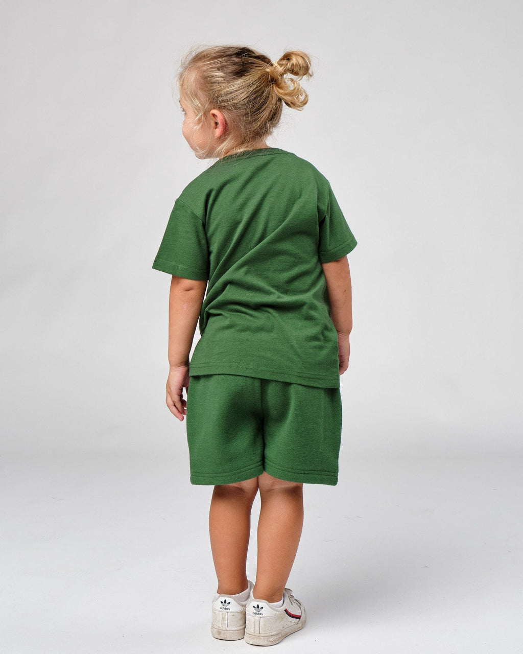 Model wearing Badge Tee (00-8) - Eden Green