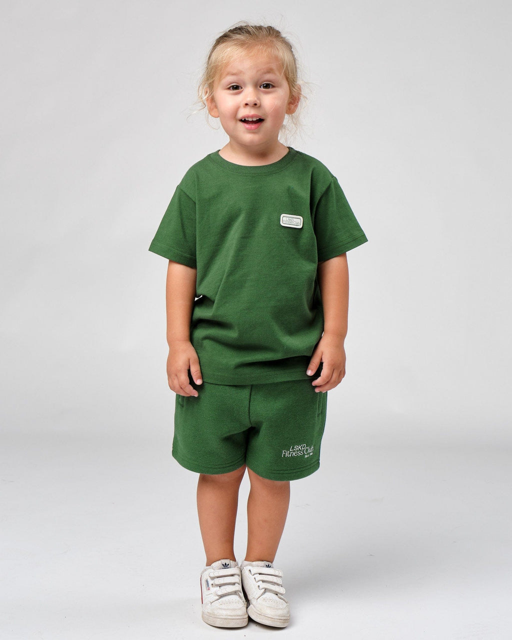 Model wearing Badge Tee (00-8) - Eden Green