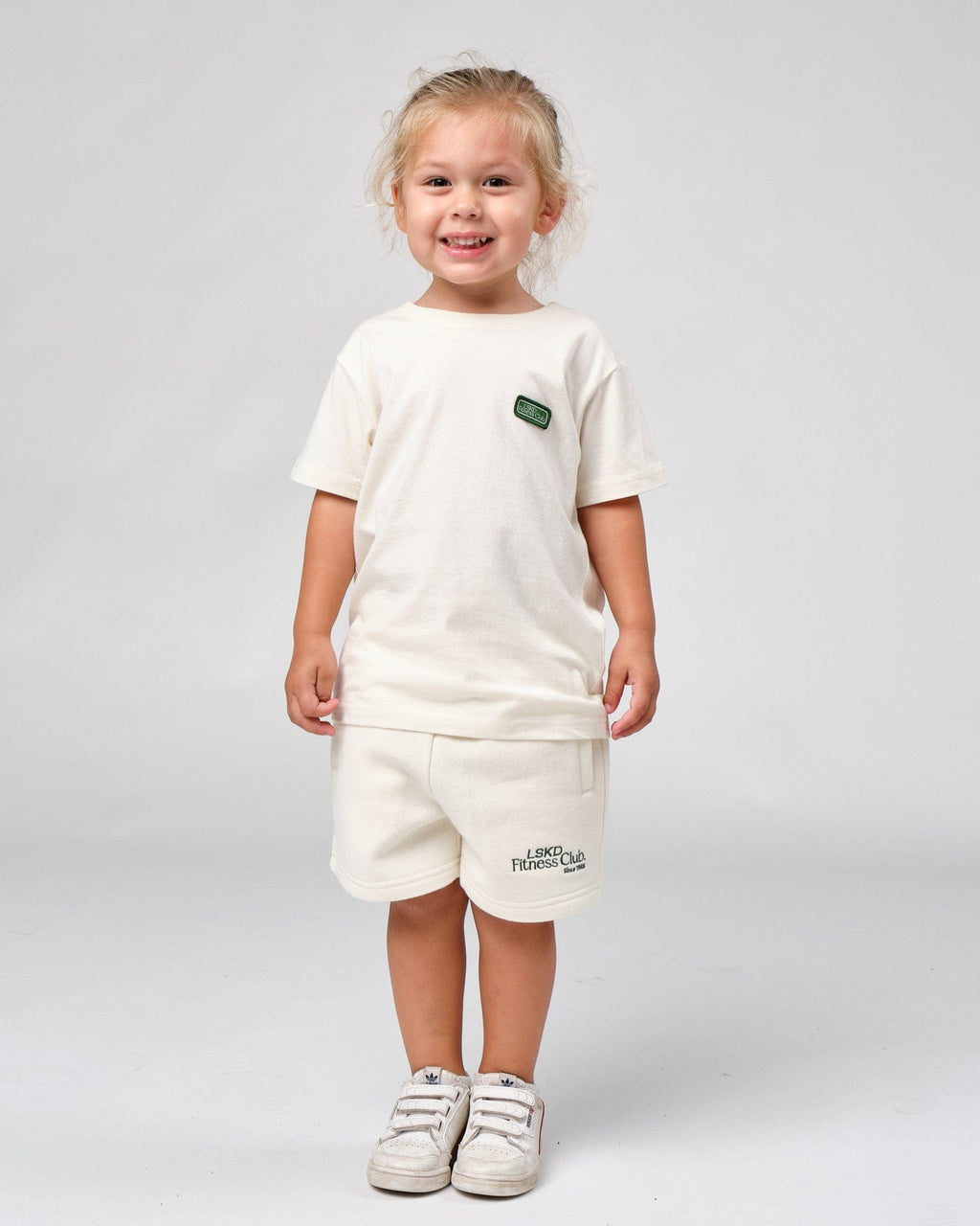 Model wearing Badge Tee (00-8) - Cream