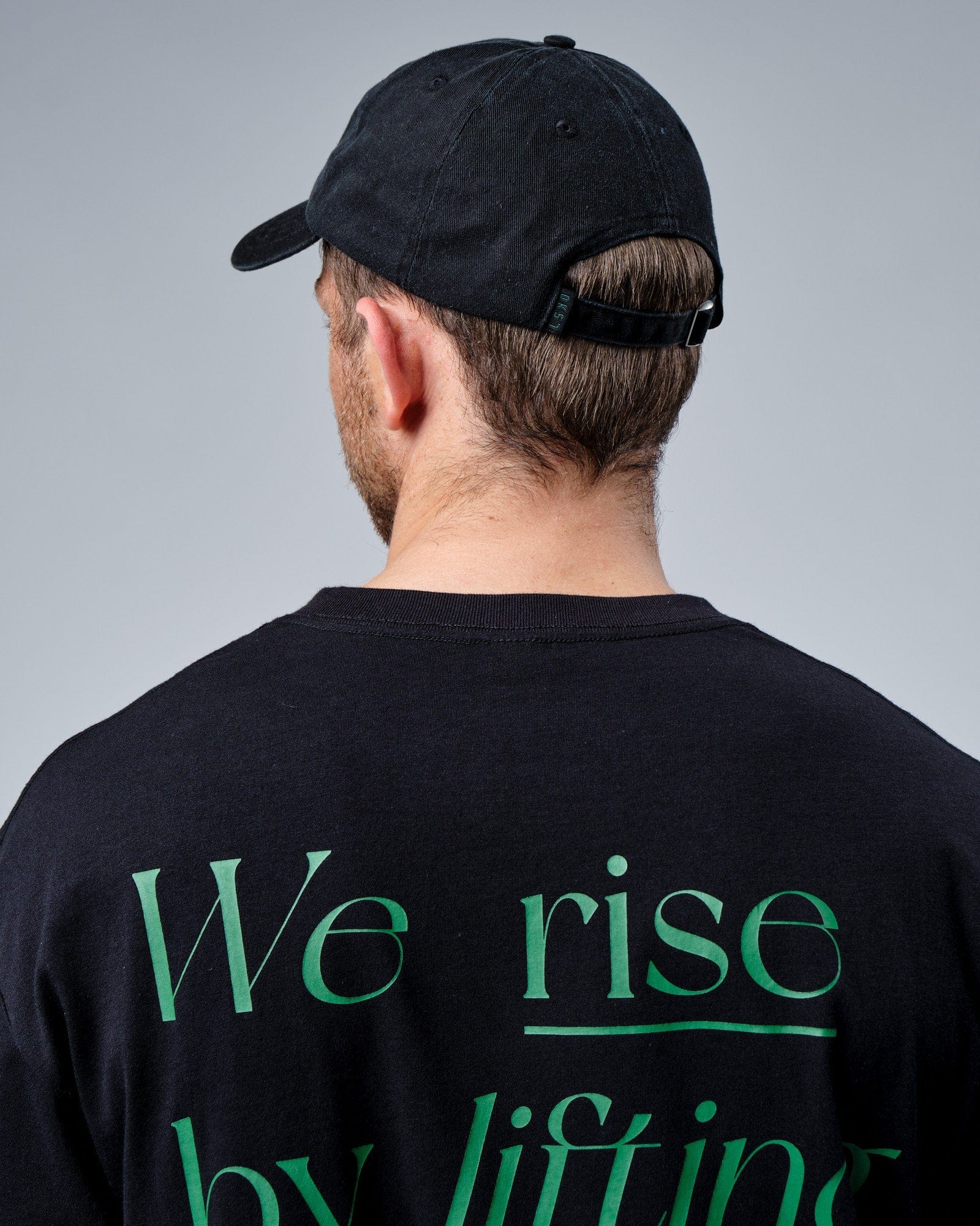 Model wearing Social Cap - Washed Black-Eden Green