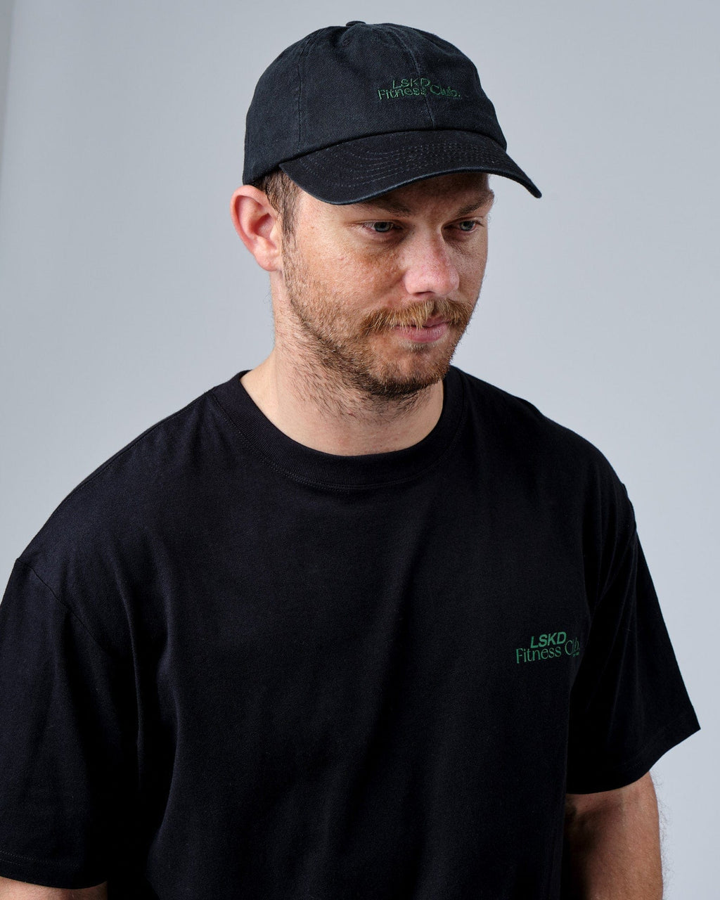 Model wearing Social Cap - Washed Black-Eden Green